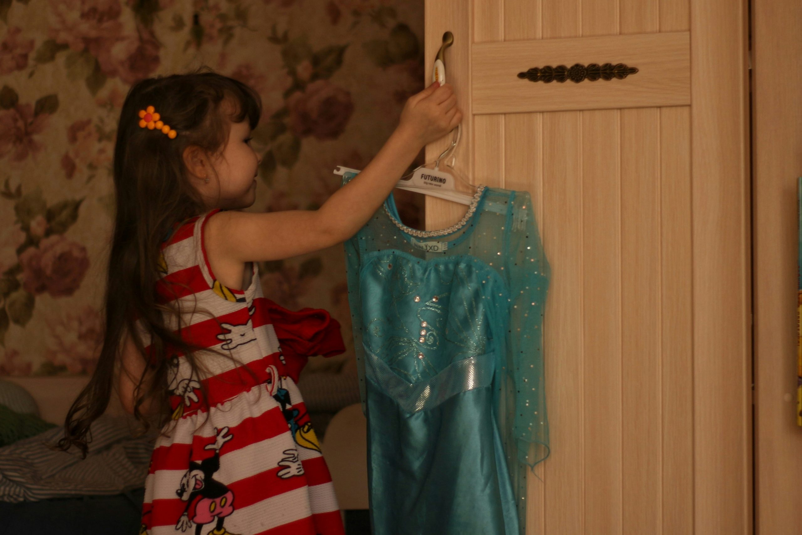 A girl looking at a dress | Source: Unsplash