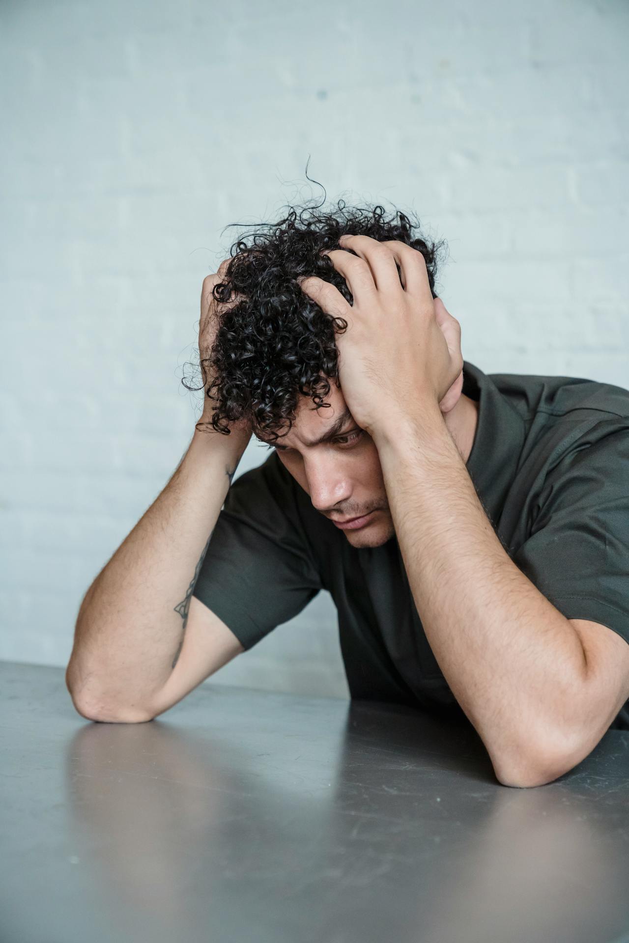 An anxious man holding his head | Source: Pexels