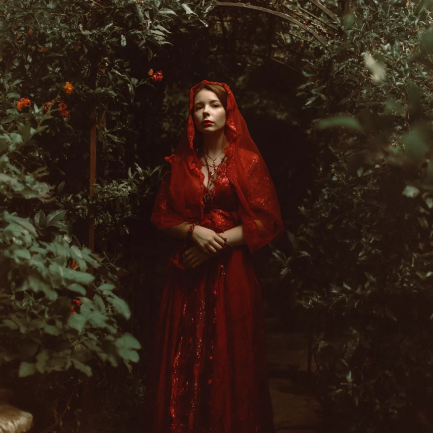 A woman in a red dress and veil | Source: Midjourney
