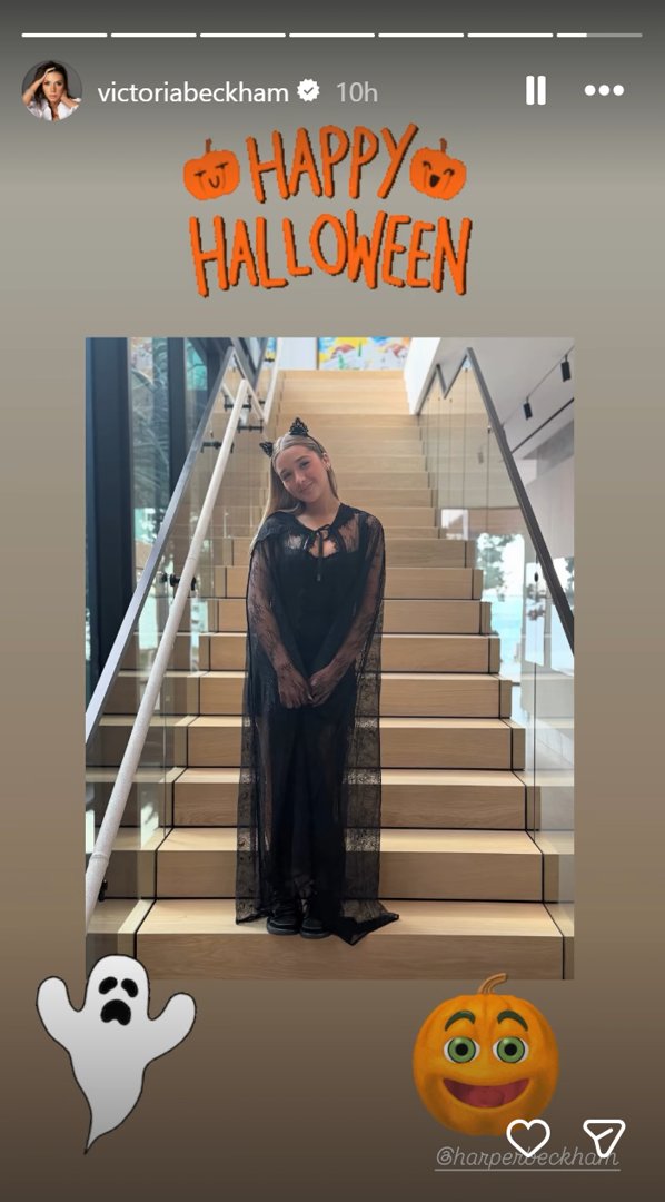 In a post dated November 1, 2025, Victoria and David Beckham's daughter, Harper Beckham, embraced a spooky-chic aesthetic in a flowing black lace cape worn over a fitted black outfit. Her look was finished with black platform shoes and a delicate cat ear headband adorned with subtle embellishments. With her hair down and a soft smile, she struck a playful pose on a staircase, delivering a modern, elegant take on the classic black cat costume. | Source: Instagram/victoriabeckham