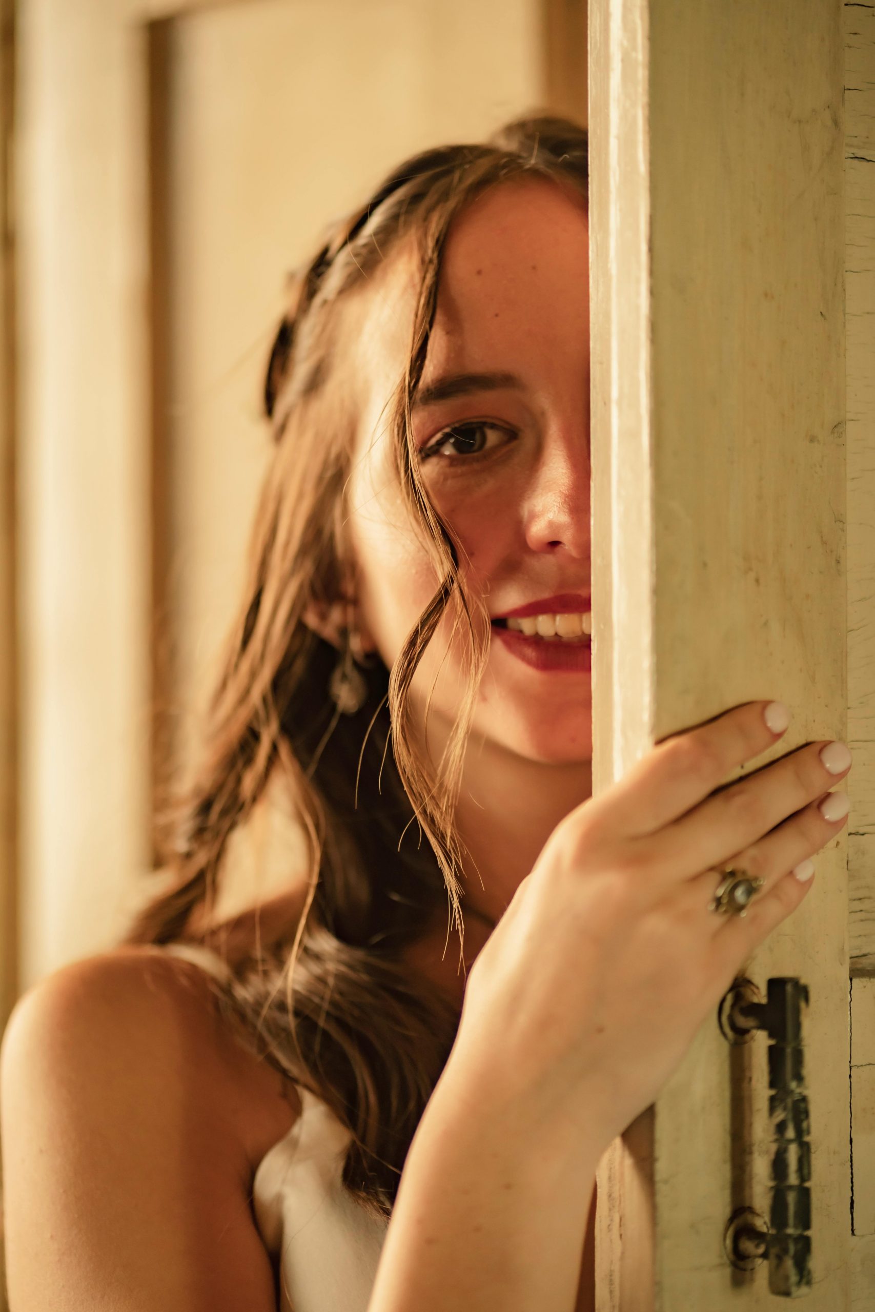 A happy woman closing a door | Source: Pexels