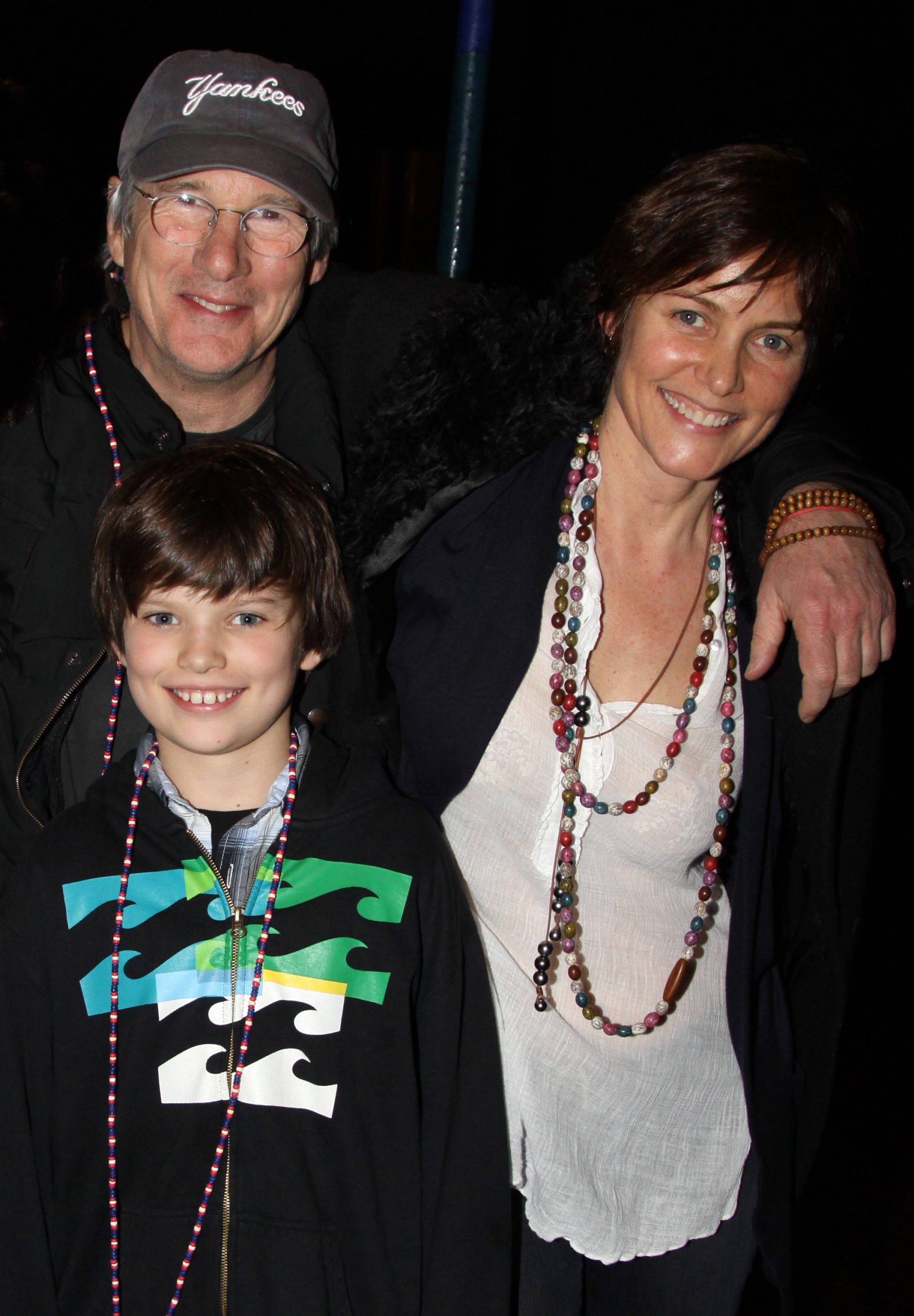 A young Homer Gere grins for the camera while posing backstage with his parents, Richard Gere and Carey Lowell, after watching the Broadway musical 