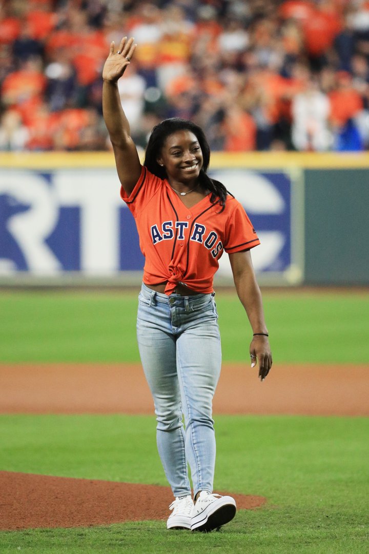 Biles waves to a roaring crowd after throwing the ceremonial first pitch ahead of Game Two of the World Series between the Houston Astros and the Washington Nationals at Minute Maid Park on October 23, 2019. The Olympic champion brought star power and Texas pride to the biggest night in baseball.