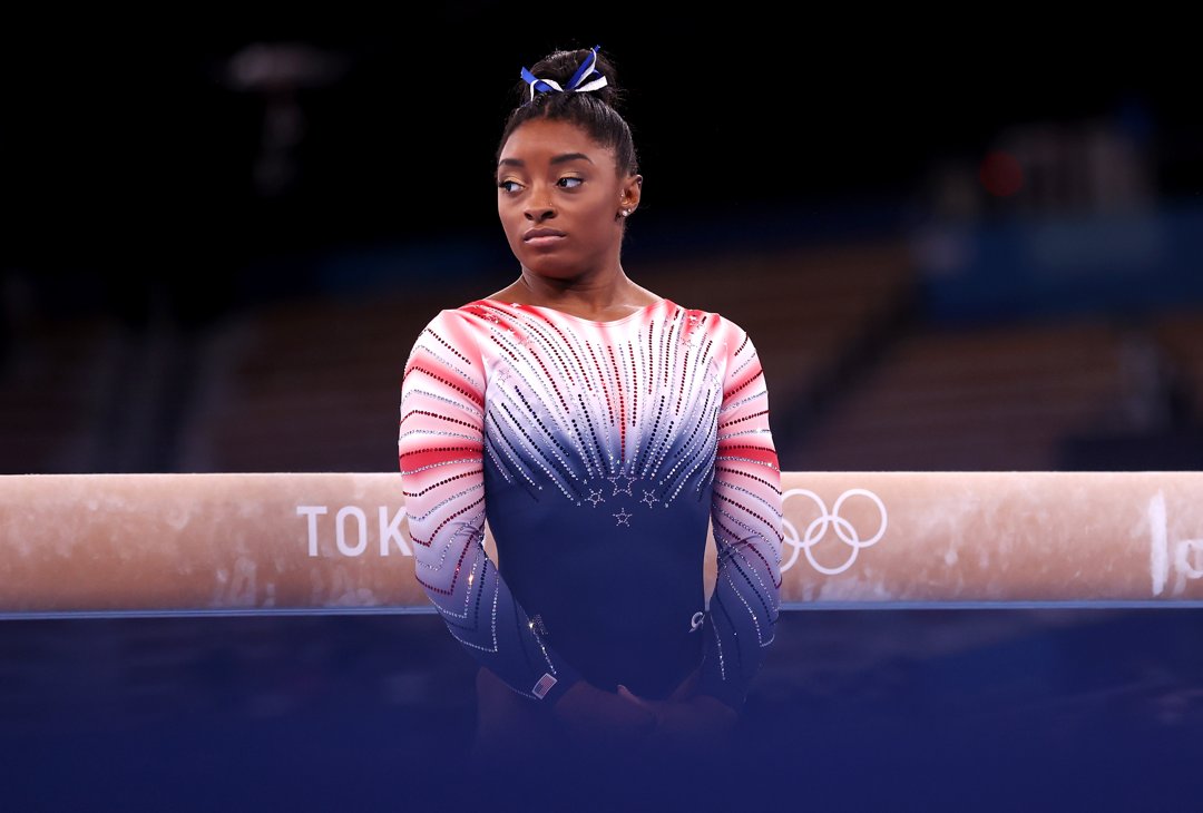 Biles stands poised before competing in the women's balance beam final at the Tokyo 2020 Olympic Games on August 3, 2021, at Ariake Gymnastics Centre. Under the global spotlight and immense pressure, the champion gymnast delivered a performance that captivated the world.