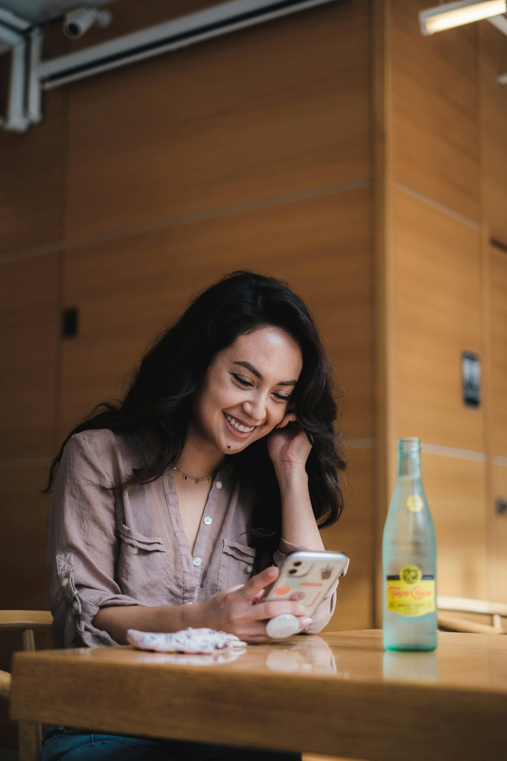 A happy woman looking at her phone | Source: Pexels