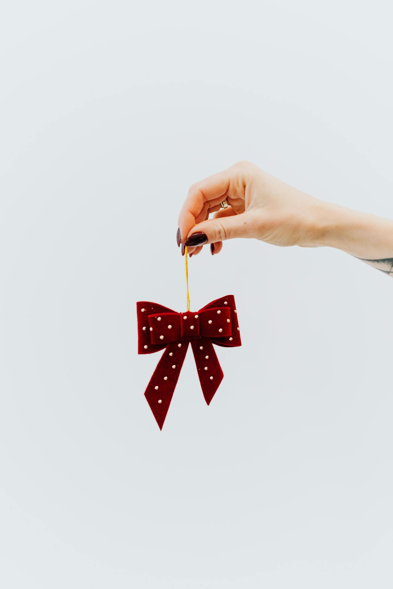 A woman holding a red bow | Source: Pexels