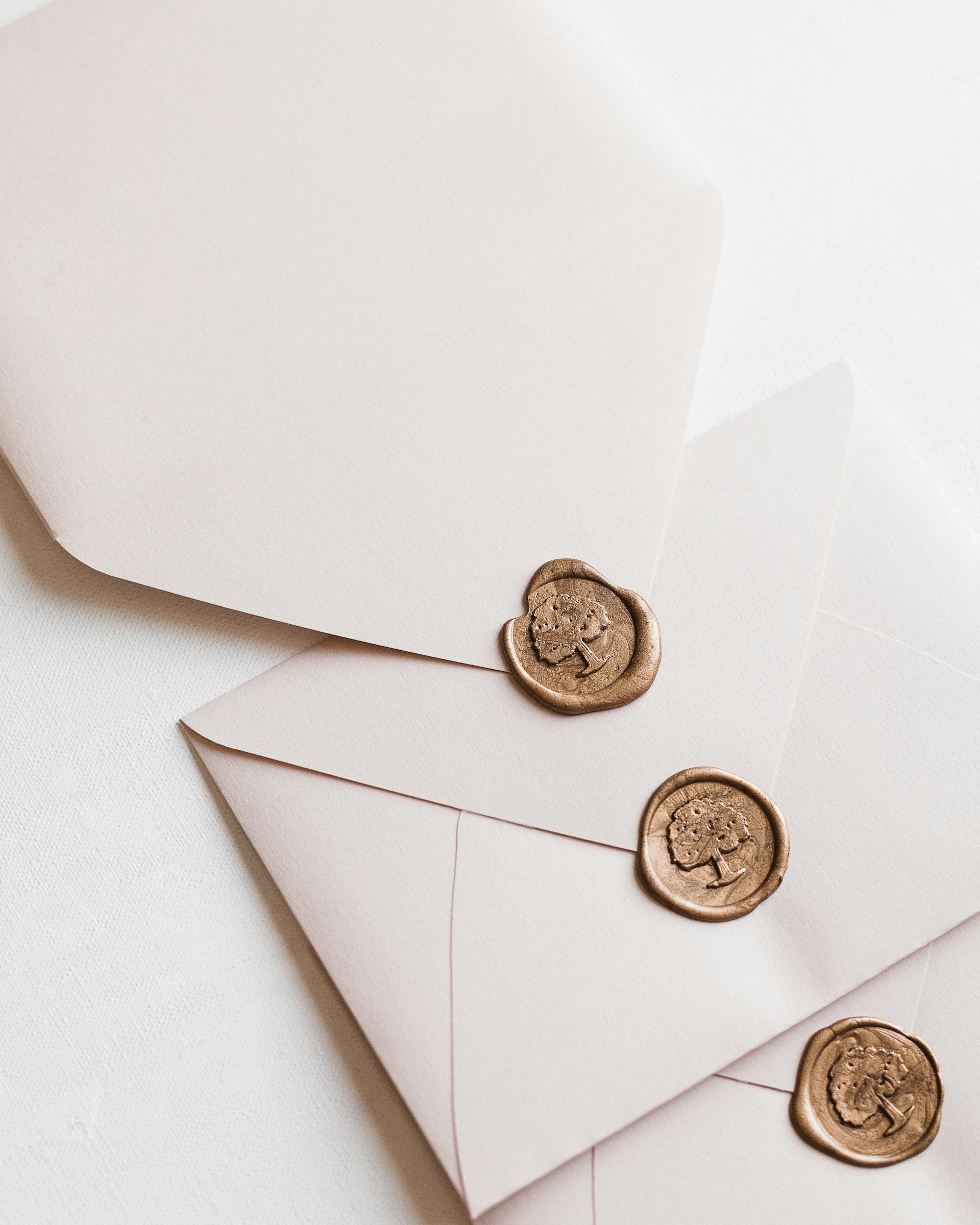 White envelopes with gold sealing | Source: Pexels
