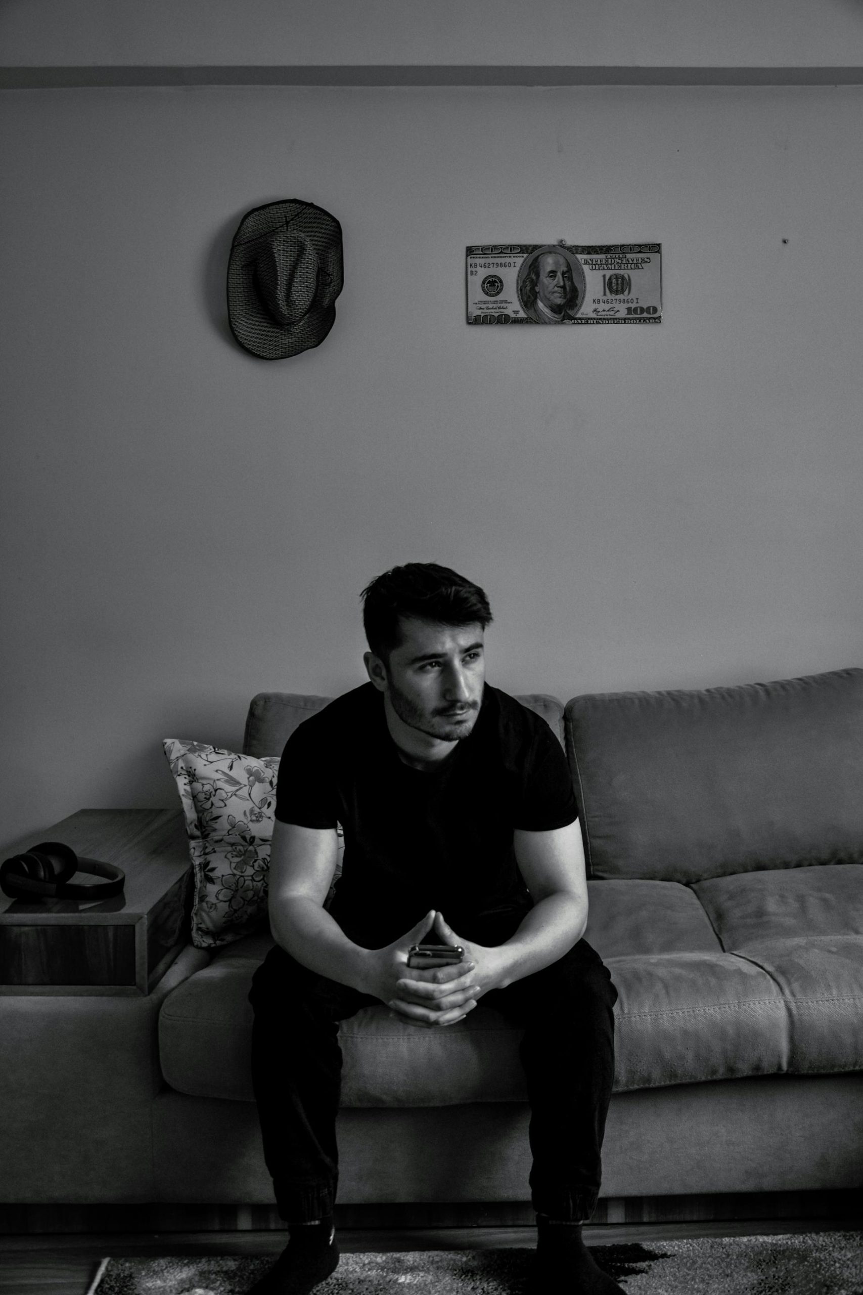 Grayscale photo of a man sitting on a sofa | Source: Pexels