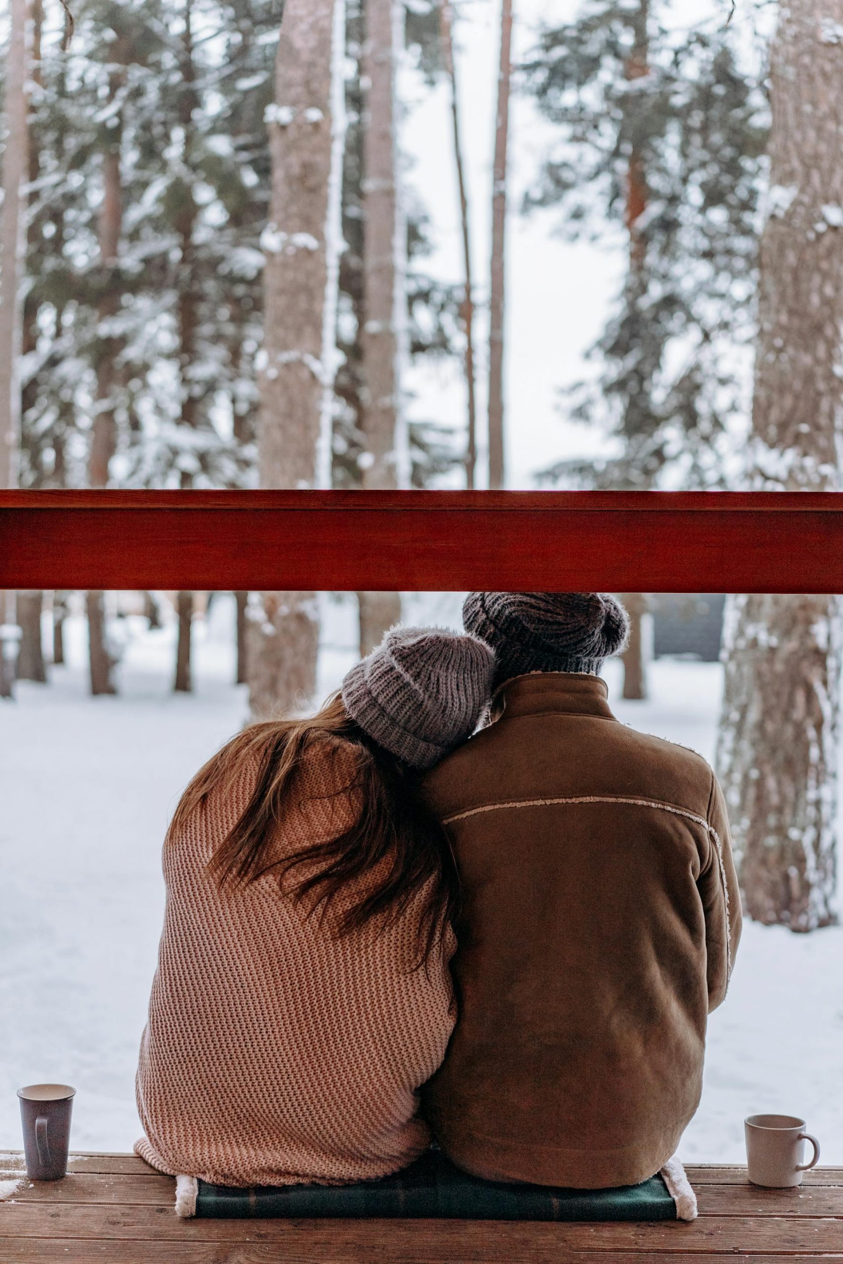 Back view shot of a couple sitting together and enjoying the winter season | Source: Pexels