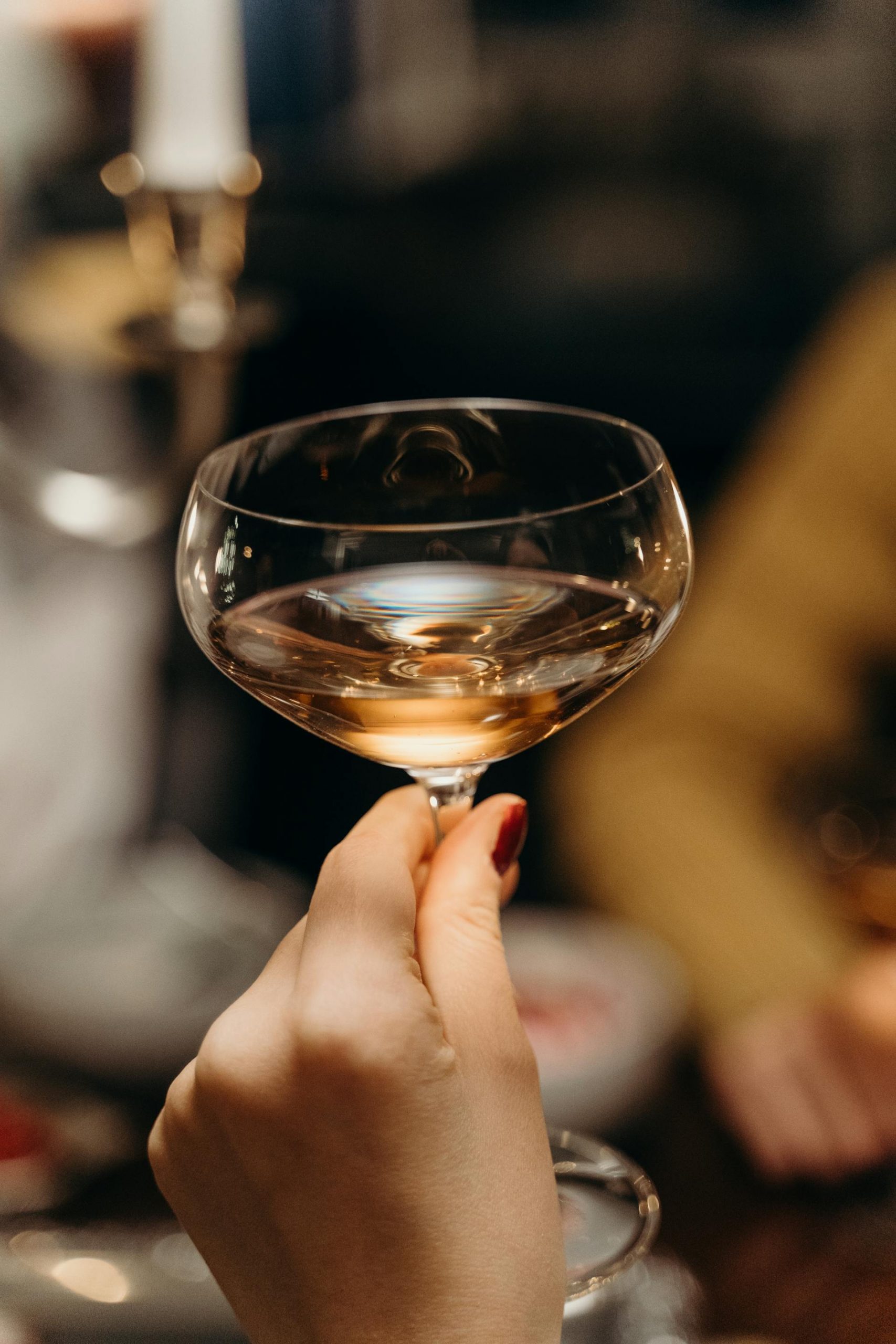 A close-up shot of a woman holding a glass of champagne | Source: Pexels