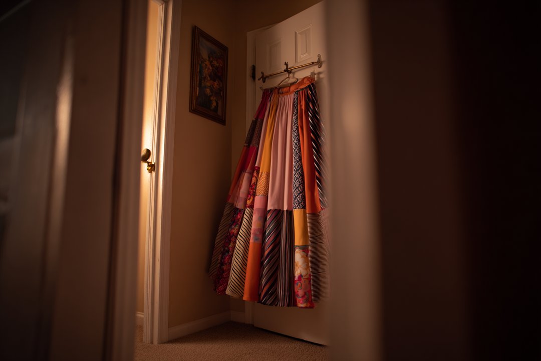 A skirt hanging on a closet door | Source: Midjourney