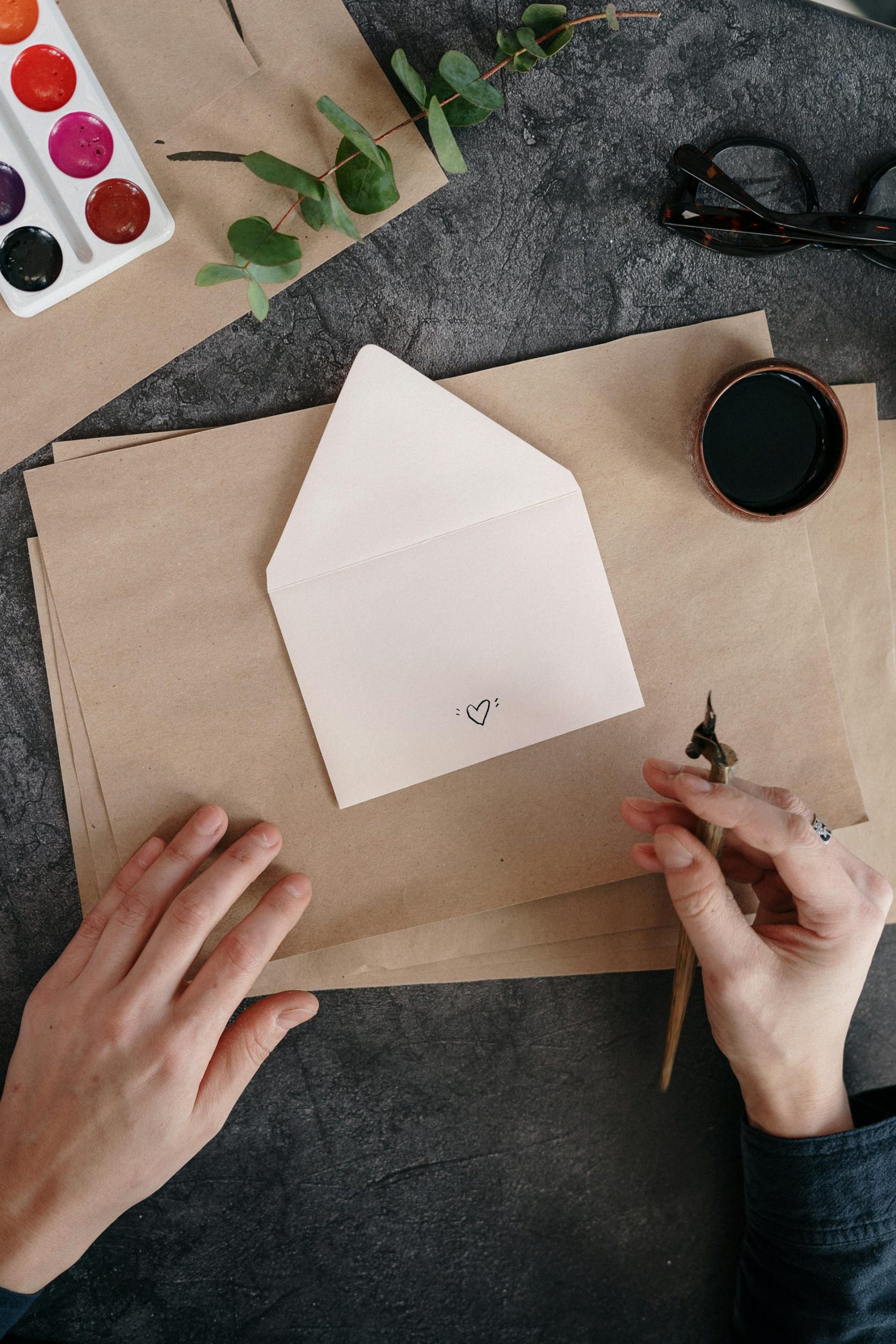 Someone creating housewarming invitations | Source: Pexels