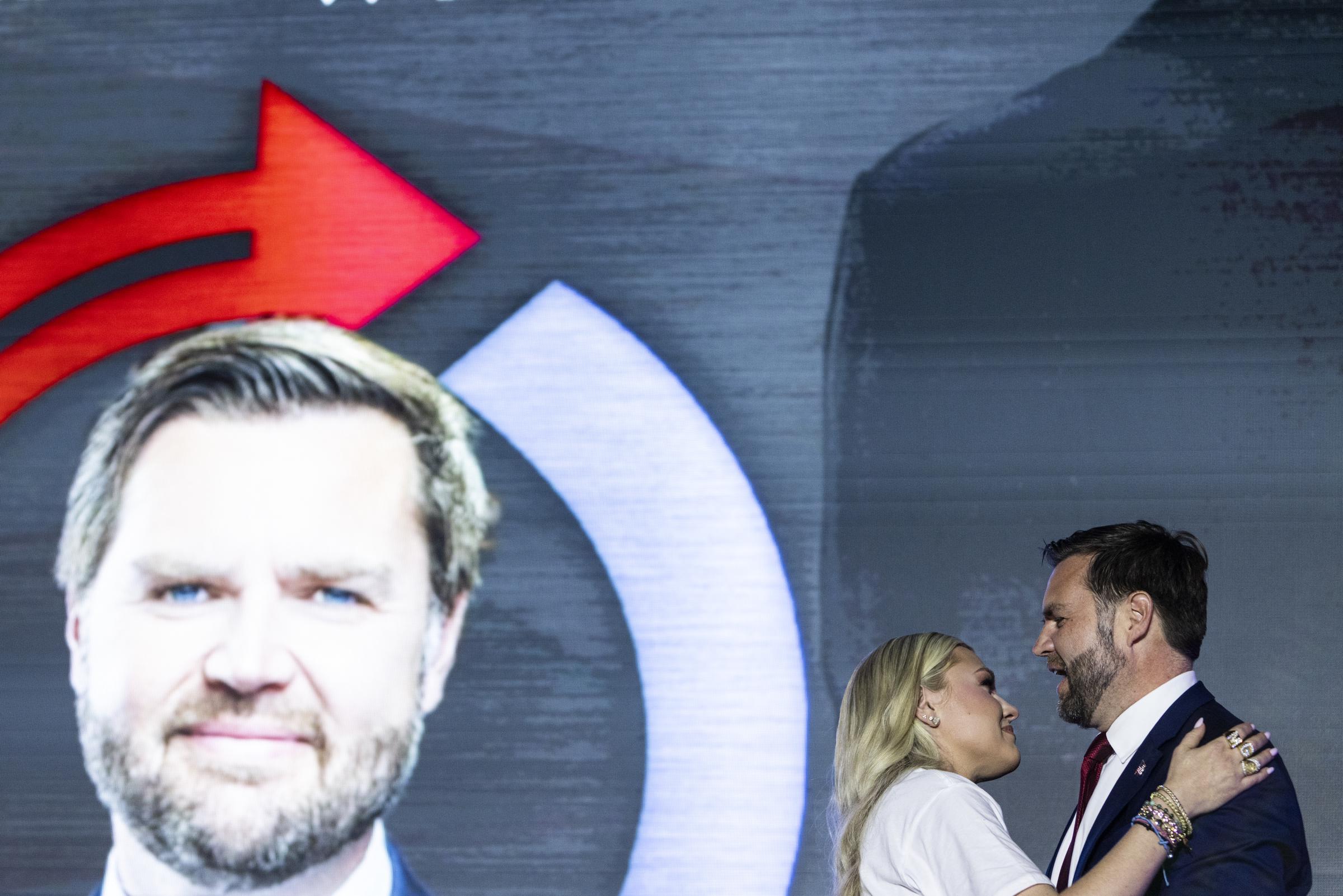 JD Vance speaking as Erika Kirk embraces him. | Source: Getty Images