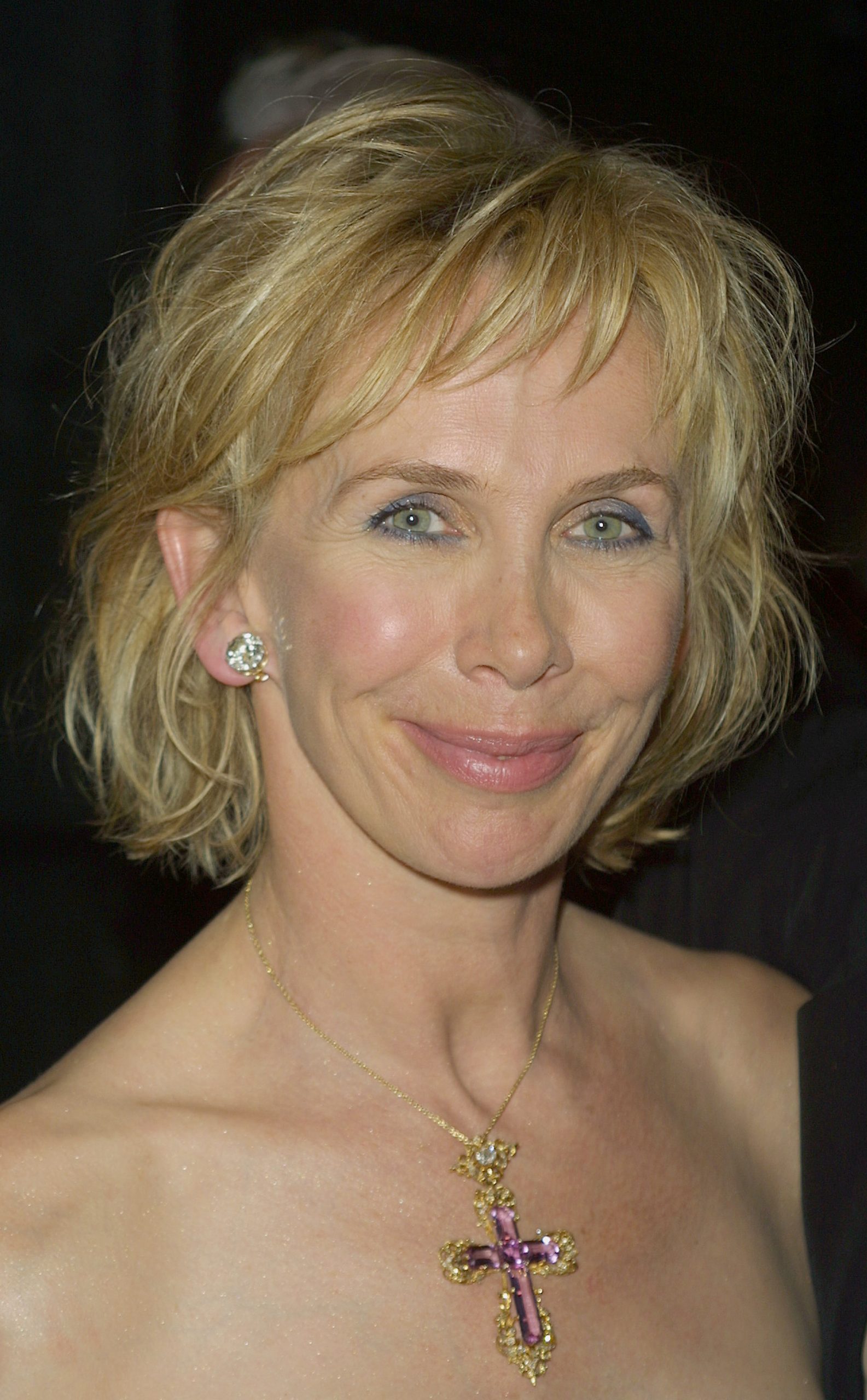 Trudie Styler, at 47, showed pronounced fine lines radiating from the corners of her eyes, a soft, closed-mouth smile with a slight turn to the left, and heavy blue eyeliner/eyeshadow highlighting her gaze, while attending the