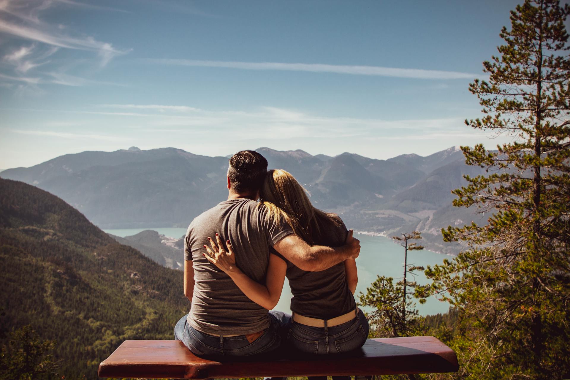 A couple sitting on a bench and enjoying the view | Source: Pexels