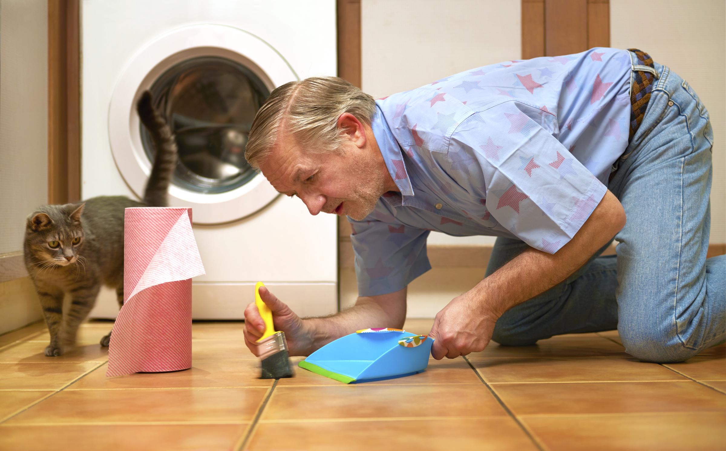 A man with obsessive compulsive disorder cleaning the floor. | Source: Getty Images