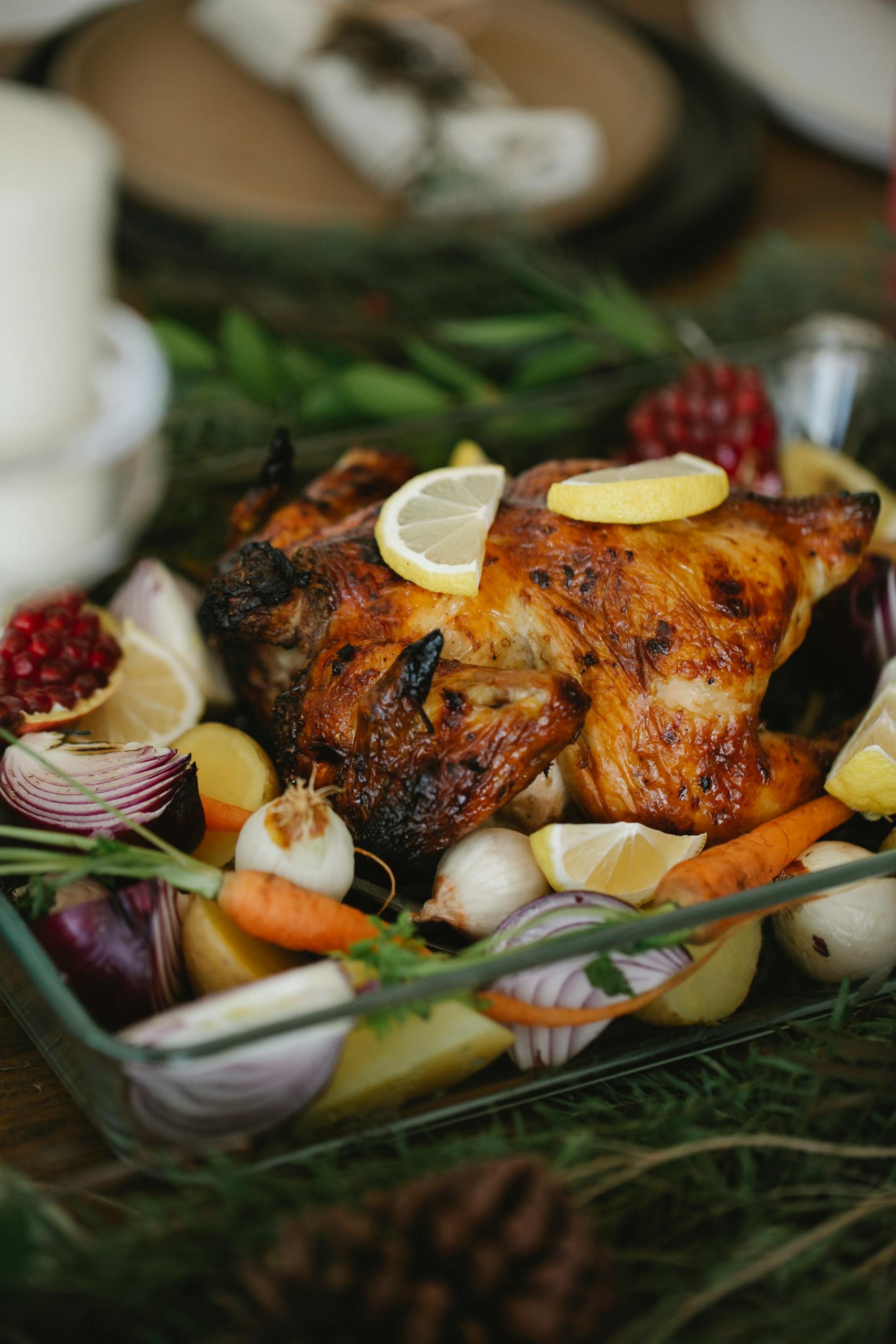 Roasted chicken served with lemons and vegetables | Source: Pexels
