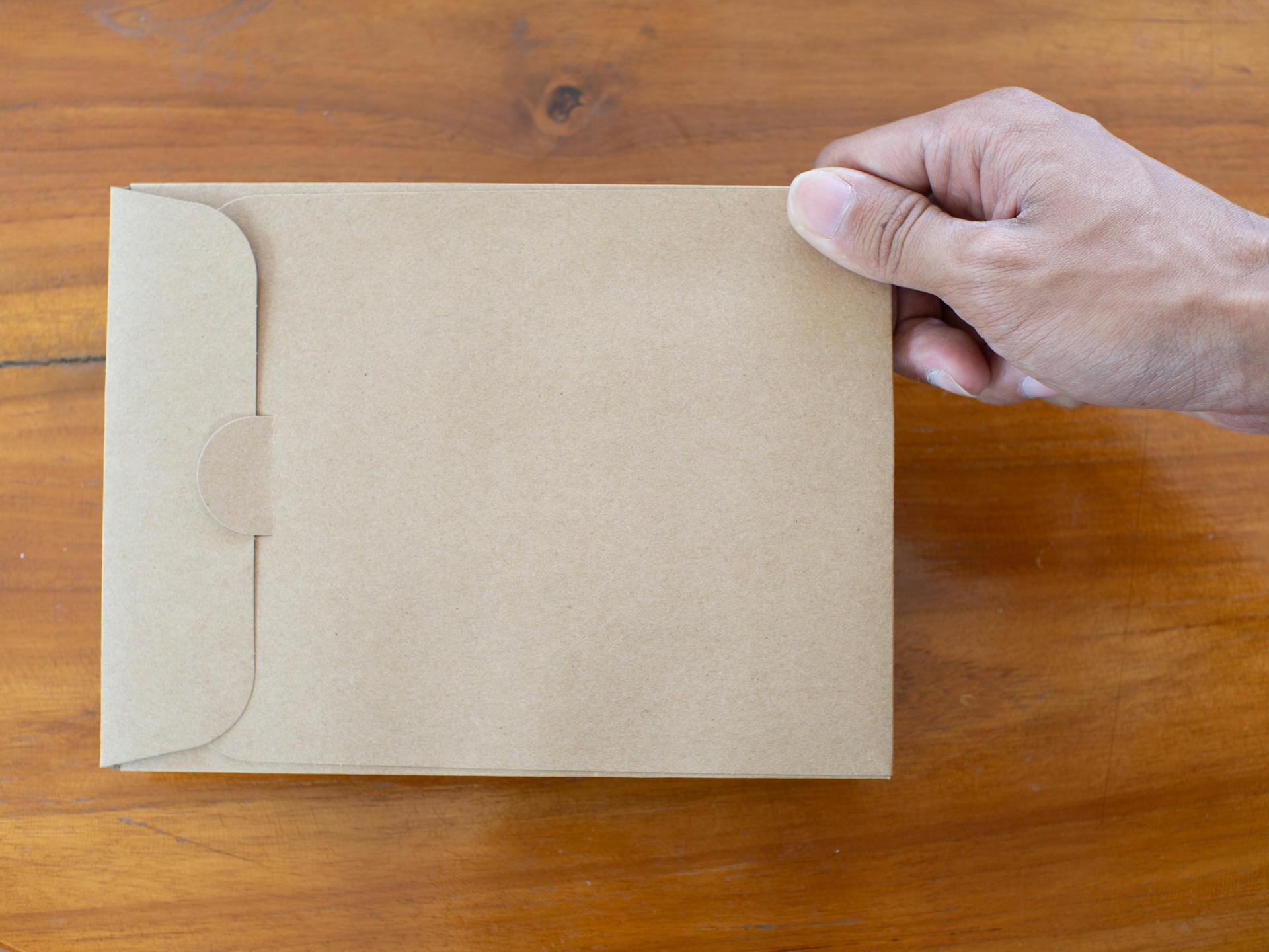 A person holding a brown envelope | Source: Pexels
