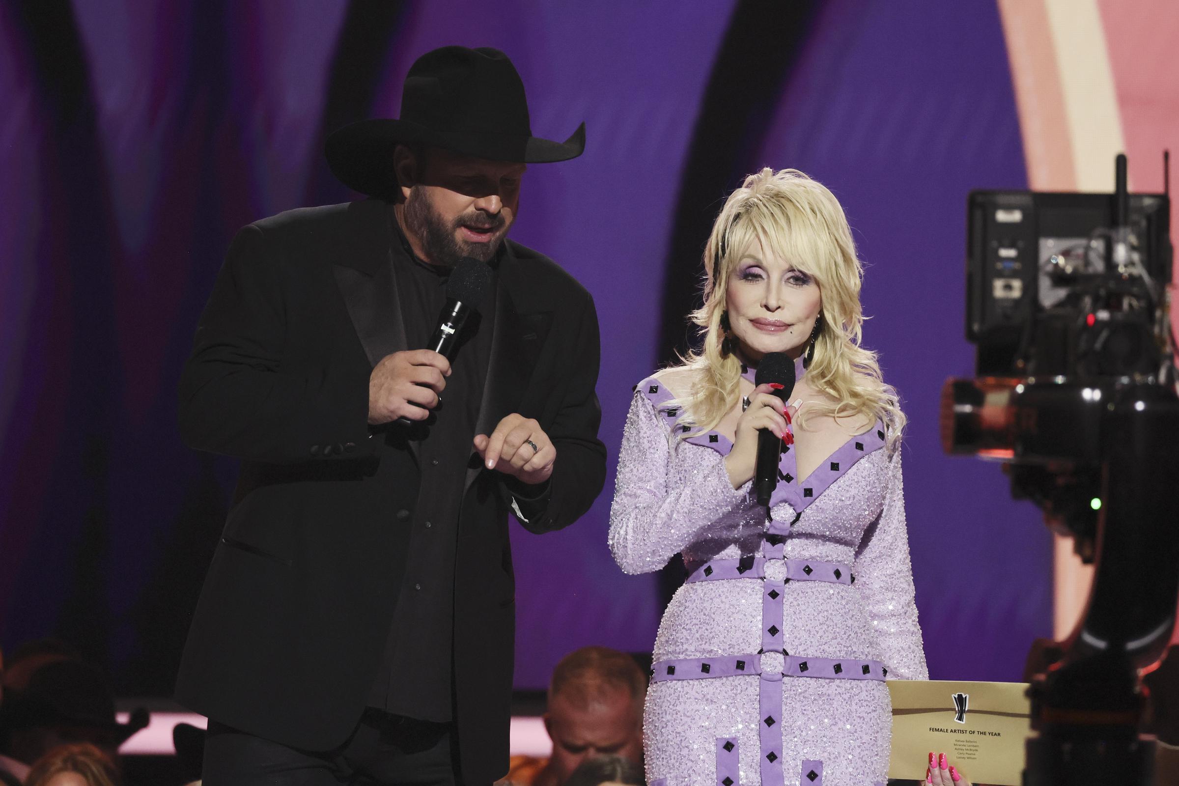 Garth Brooks and Dolly Parton speak onstage during the 58th Academy Of Country Music Awards at The Ford Center at The Star on May 11, 2023, in Frisco, Texas | Source: Getty Images