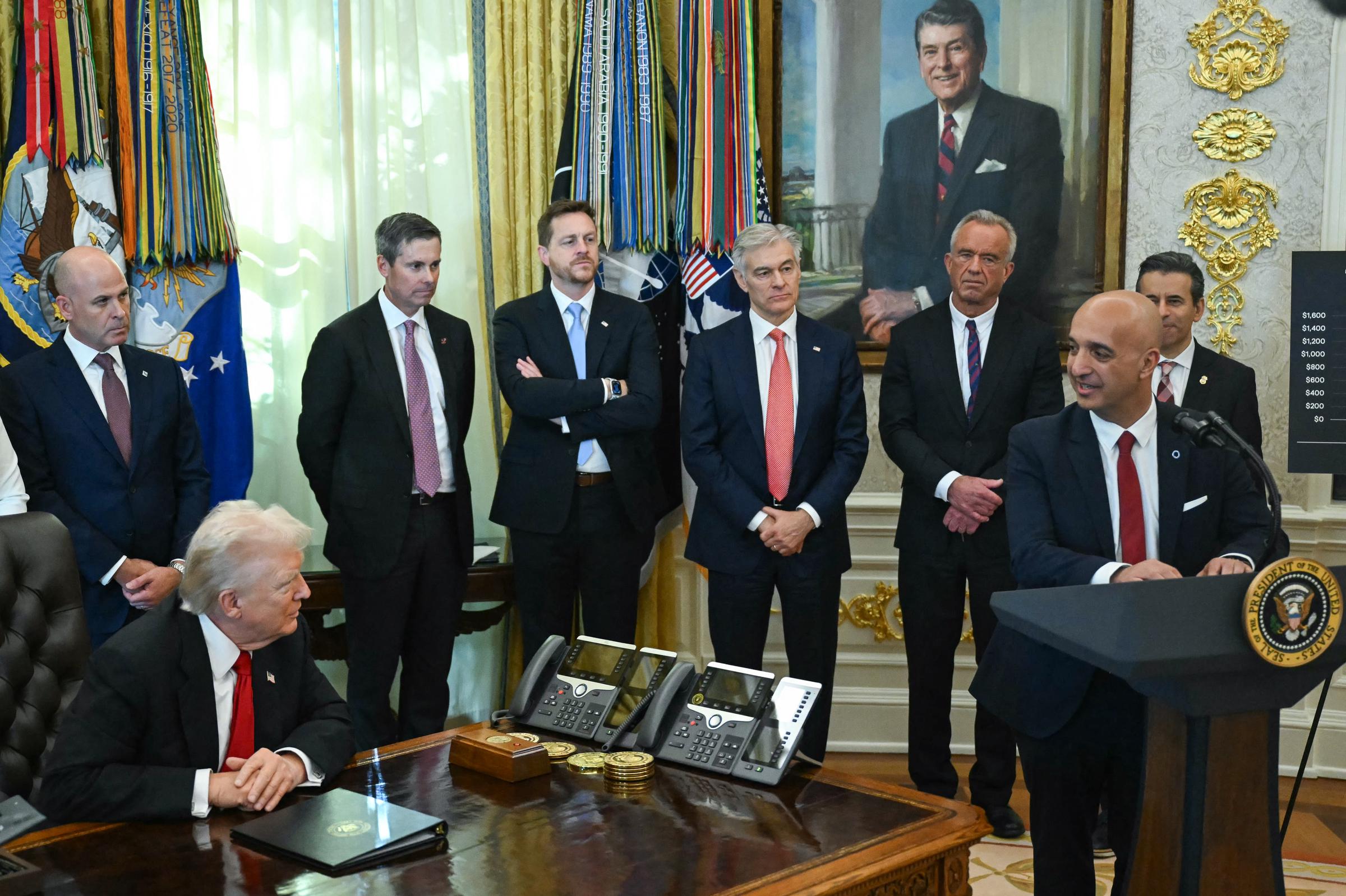 Donald Trump looks on as Maziar Mike Doustdar, CEO of Novo Nordisk, speaks in the Oval Office during an event about weight-loss drugs at the White House in Washington, DC, on November 6, 2025 | Source: Getty Images