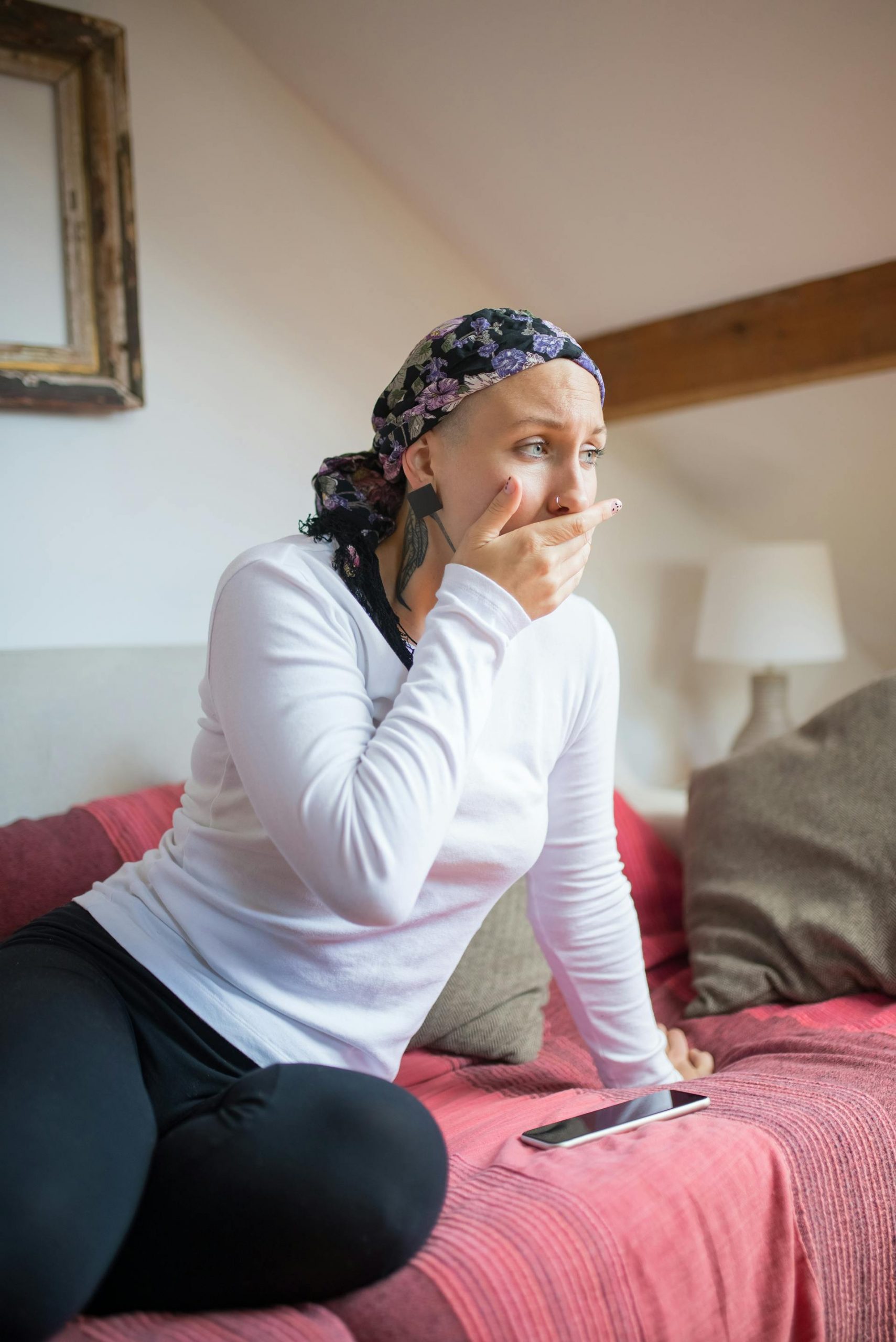 A woman in a headscarf sitting on a sofa | Source: Pexels