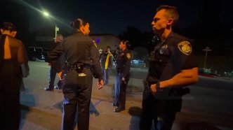 Officers standing outside Jeff Bezos' Beverly Hills mansion, where Kris Jenner's birthday party took place. | Source: Instagram/tmz_tv