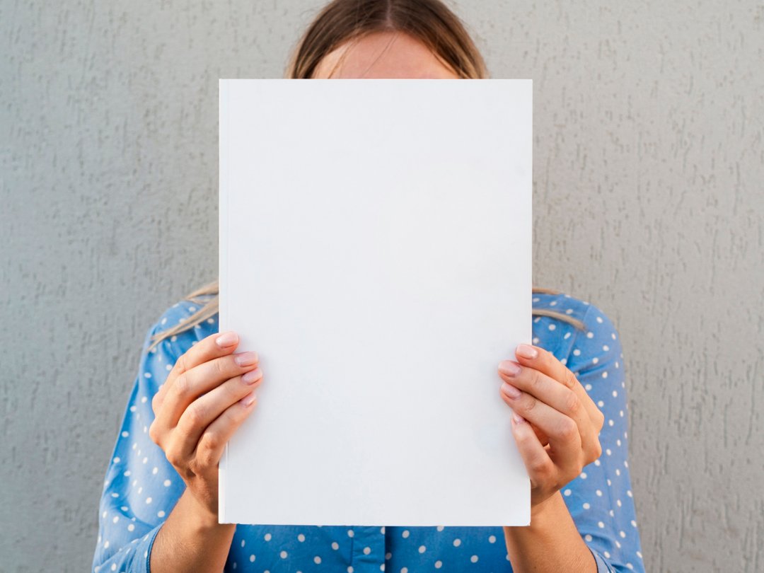 A woman holding a sheet of paper | Source: Freepik