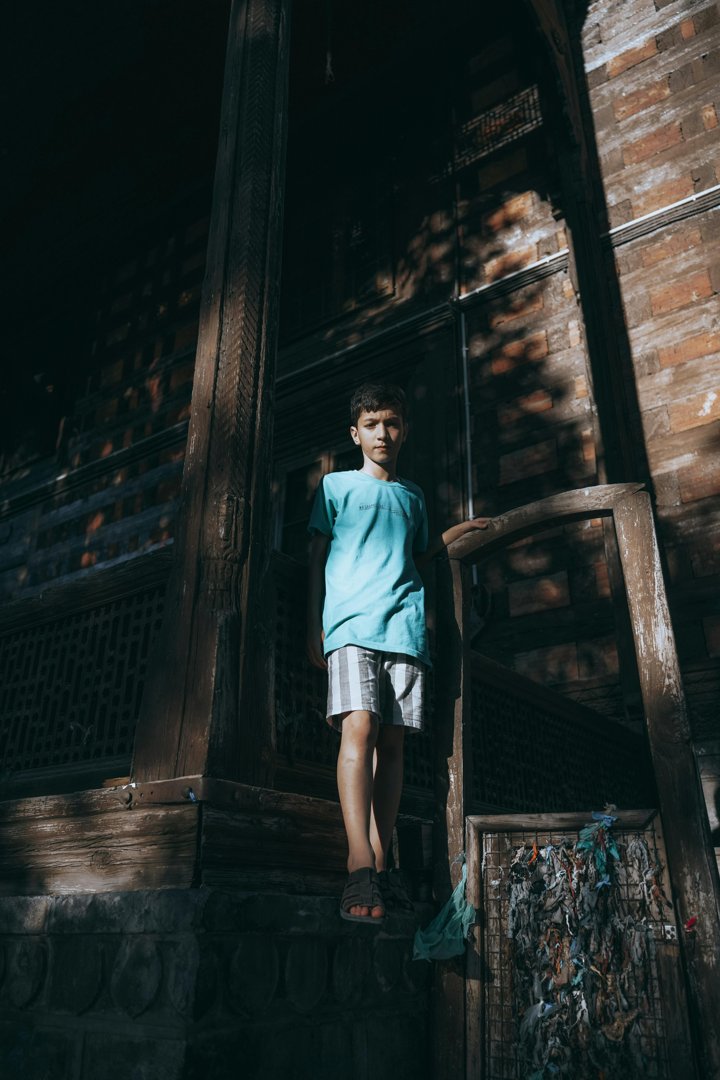 A boy standing near an old building | Source: Pexels