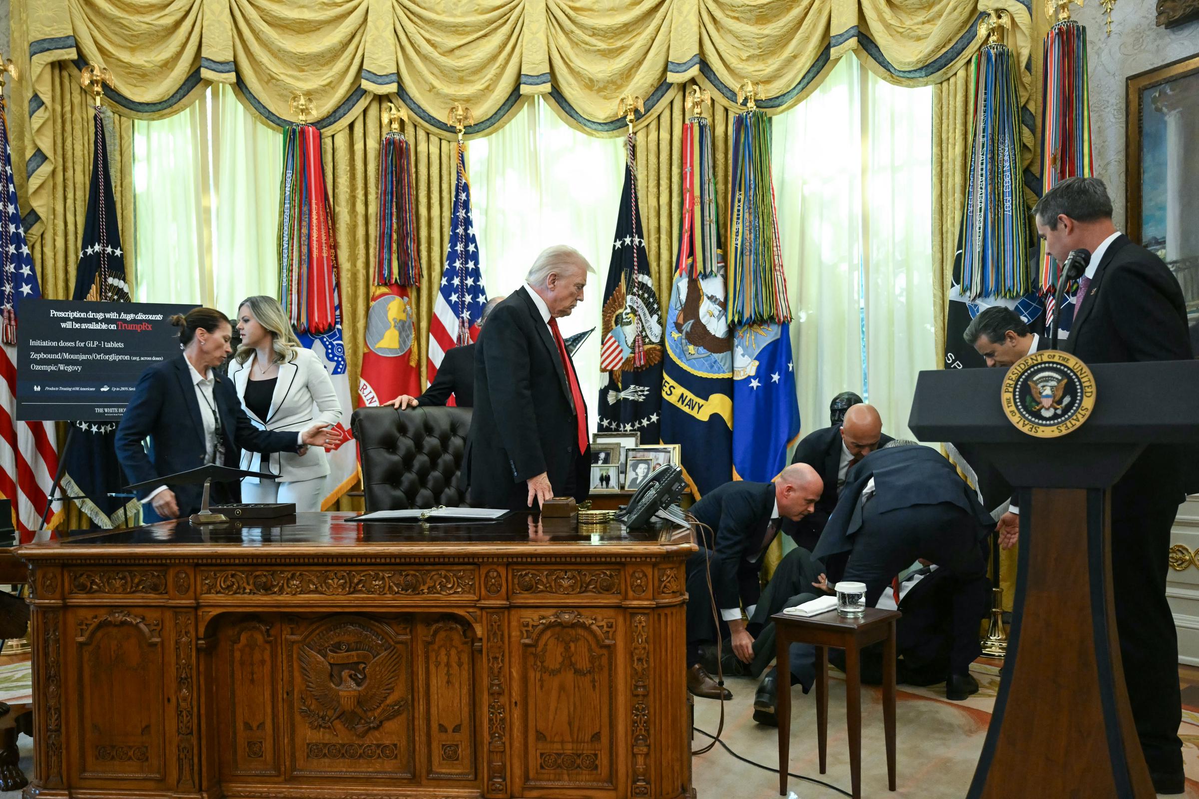 Donald Trump watches as others rush to help Gordon Findlay after he fainted in the Oval Office of the White House in Washington, DC, on November 6, 2025 | Source: Getty Images