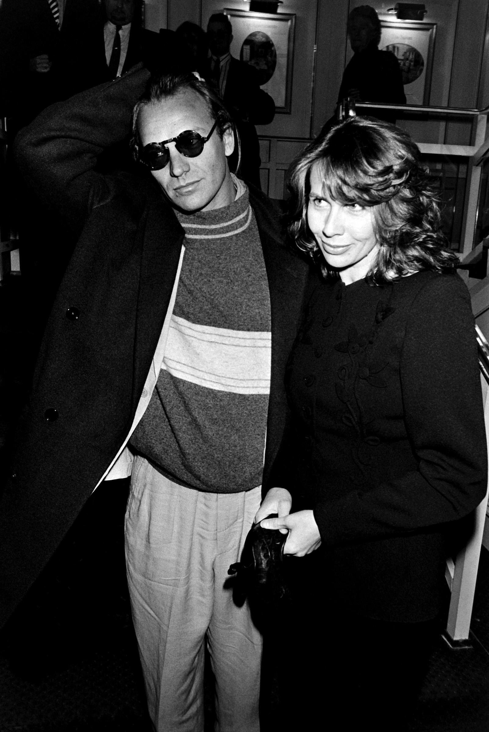 Trudie Styler, at roughly 26, appeared with a soft, youthful face, featuring a distinctive slightly asymmetrical smile, strong bone structure, and a short, feathered haircut typical of the era, while attending an awards ceremony with Sting circa 1980 in London, England.