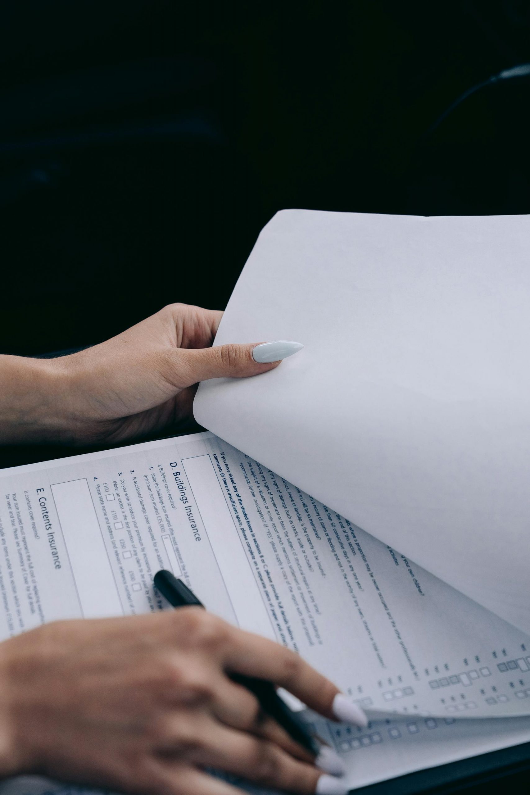 A woman holding a document | Source: Pexels
