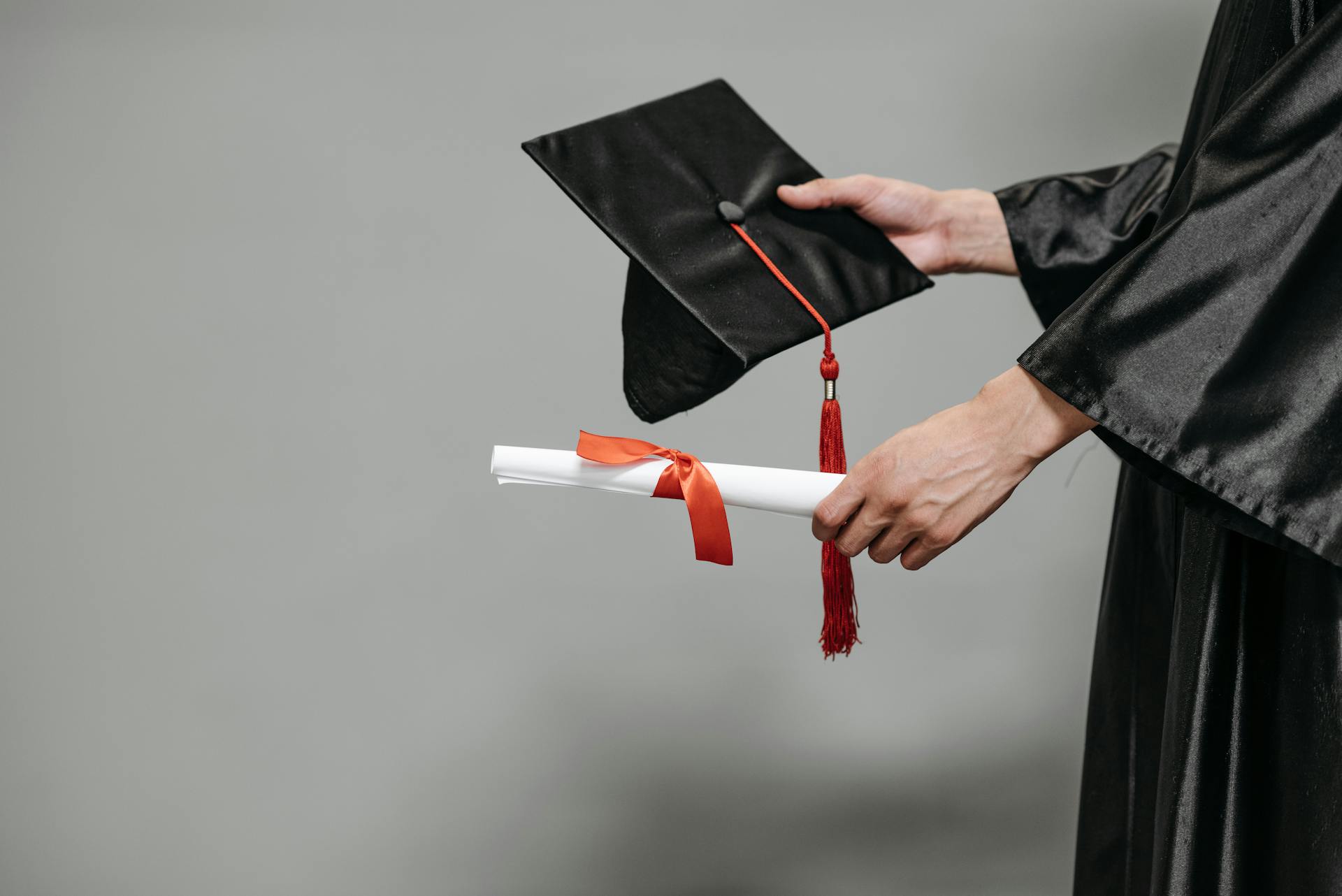 A person holding a graduation cap and a diploma | Source: Pexels