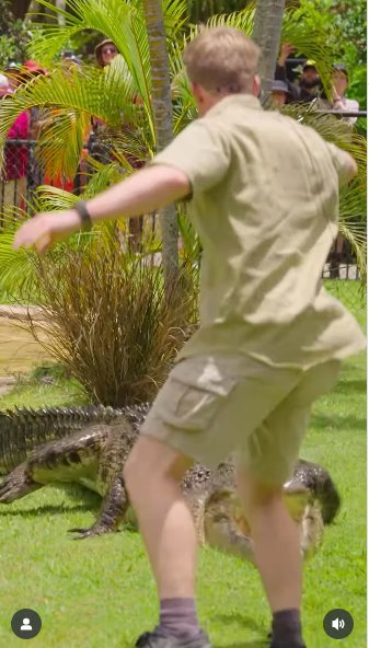 Robert Irwin jumping back as a crocodile lunges forward. | Source: Instagram/robertirwinphotography