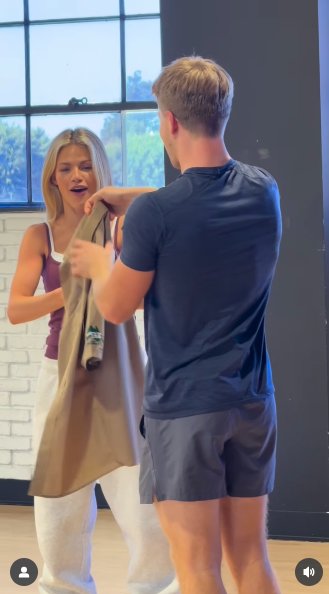 Robert Irwin gifting Witney Carson a khaki park ranger shirt, posted on November 8, 2025. | Source: Instagram/australiazoo