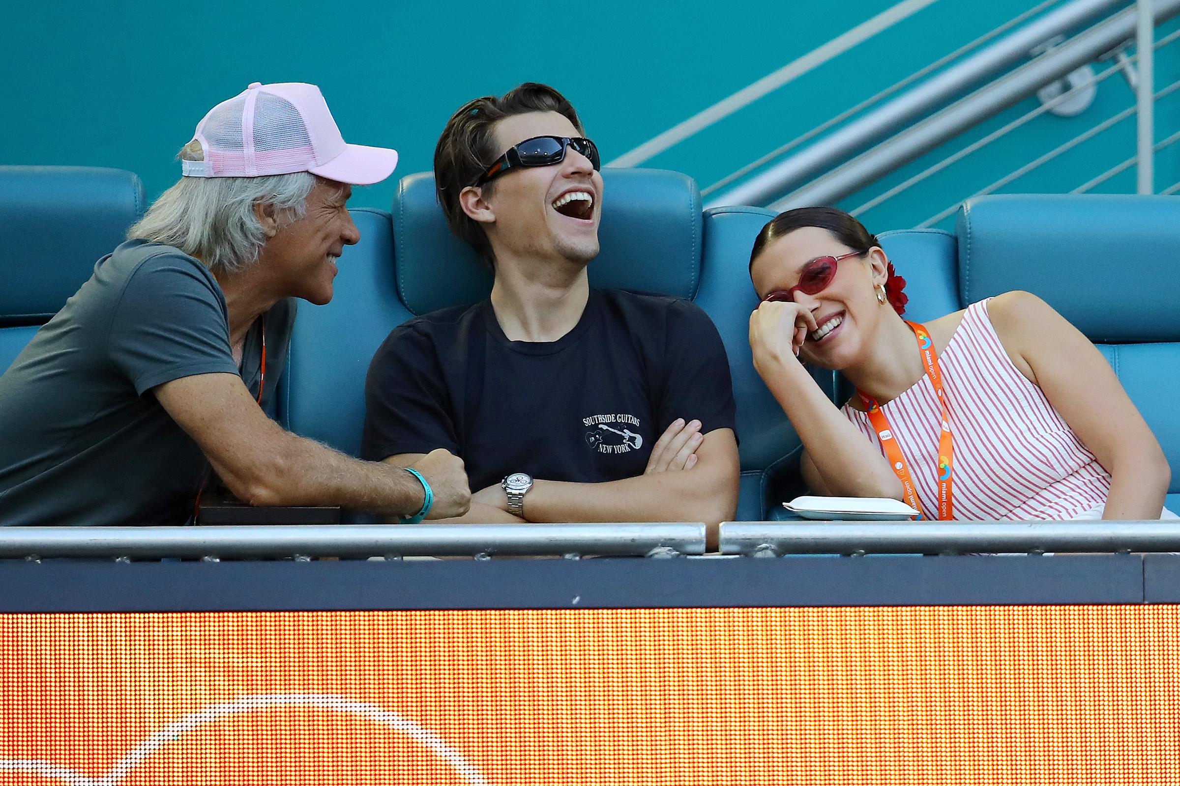 Jon Bon, Jake Bongiovi, and Millie Bobby Brown attend the Novak Djokovic of Serbia and Sebastian Korda of the United States match on Day 10 of the Miami Open on March 27, 2025, in Florida. | Source: Getty Images