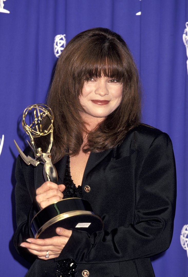 Valerie Bertinelli attends the 45th Annual Primetime Emmy Awards, wearing her hair in a soft brunnete shade that nearly matches the tone of her lipstick. Her hairstyle features a fringe that frames her face, with gentle curls that fall just below her chin for an elegant finish.