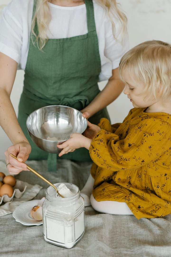 A mom and her baby cooking | Source: Pexels