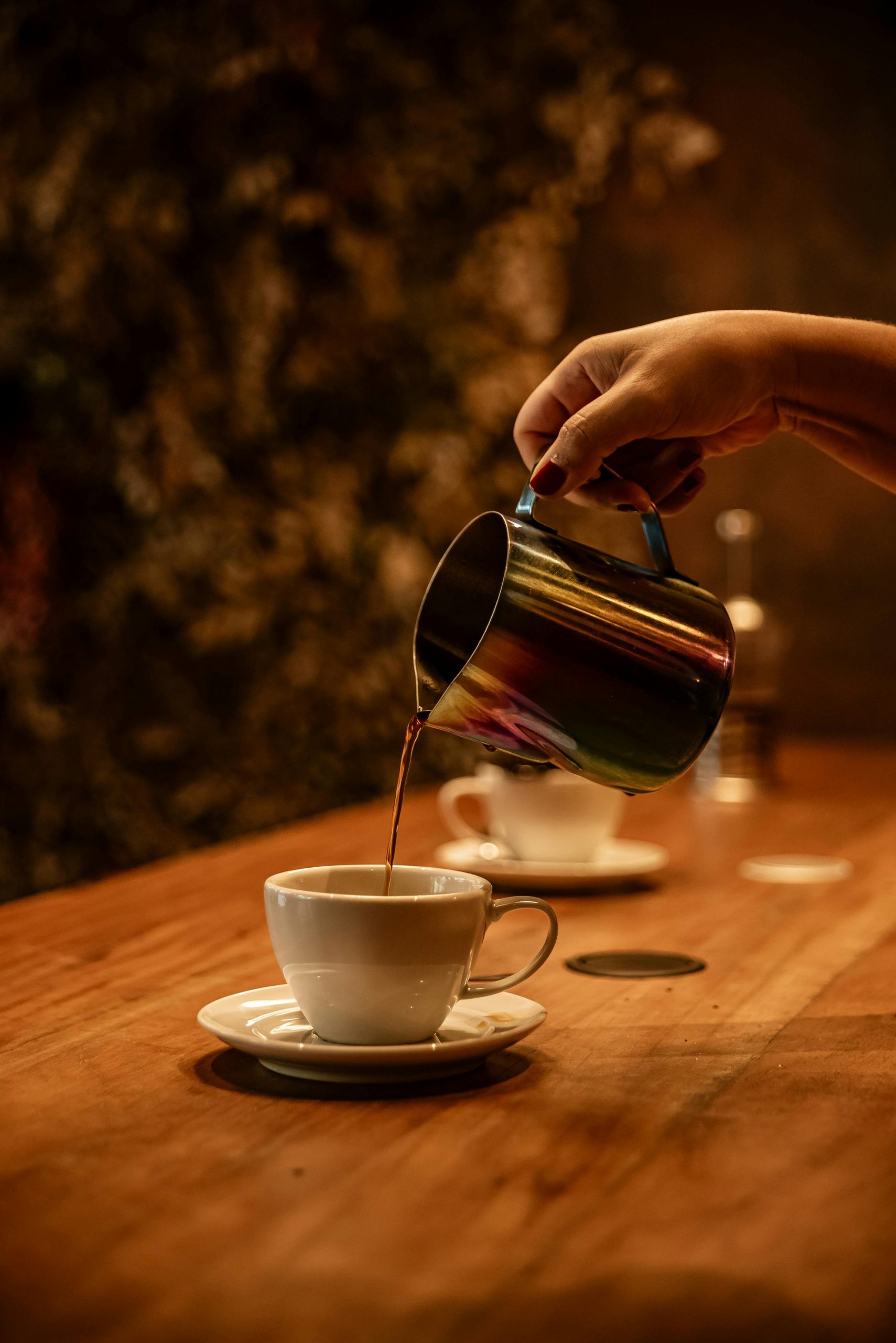 A woman's hand pouring coffee | Source: Pexels