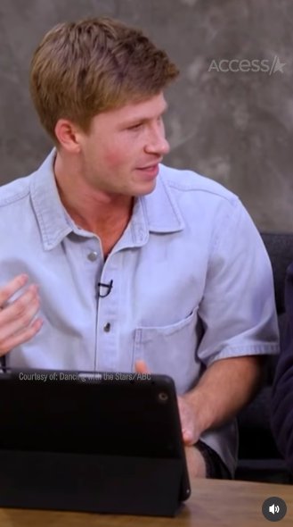 Robert Irwin explaining to Witney Carson (off-camera) that they have received a mysterious video call, posted on November 12, 2025. | Source: Instagram/accesshollywood