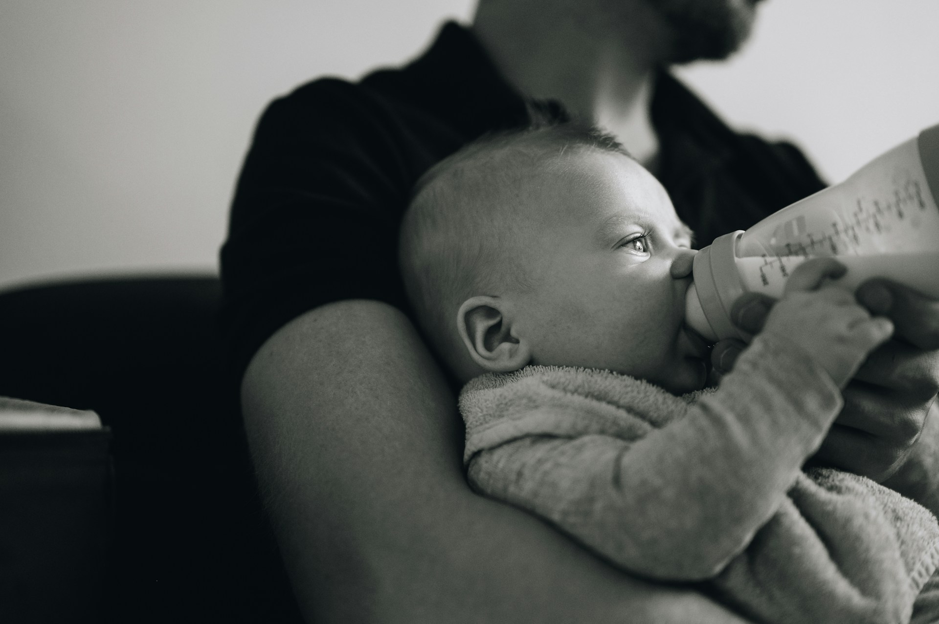A father feeding his baby | Source: Unsplash
