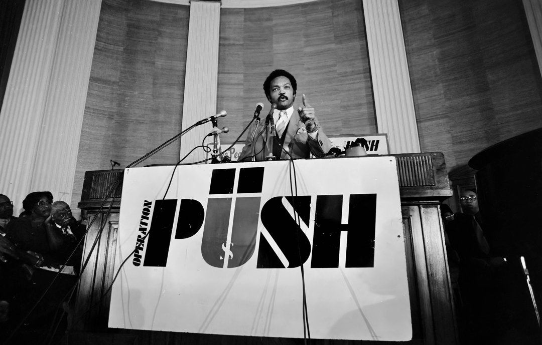 Jesse Jackson speaks from a lectern at the headquarters of Operation PUSH on July 17, 1981 | Source: Getty Images