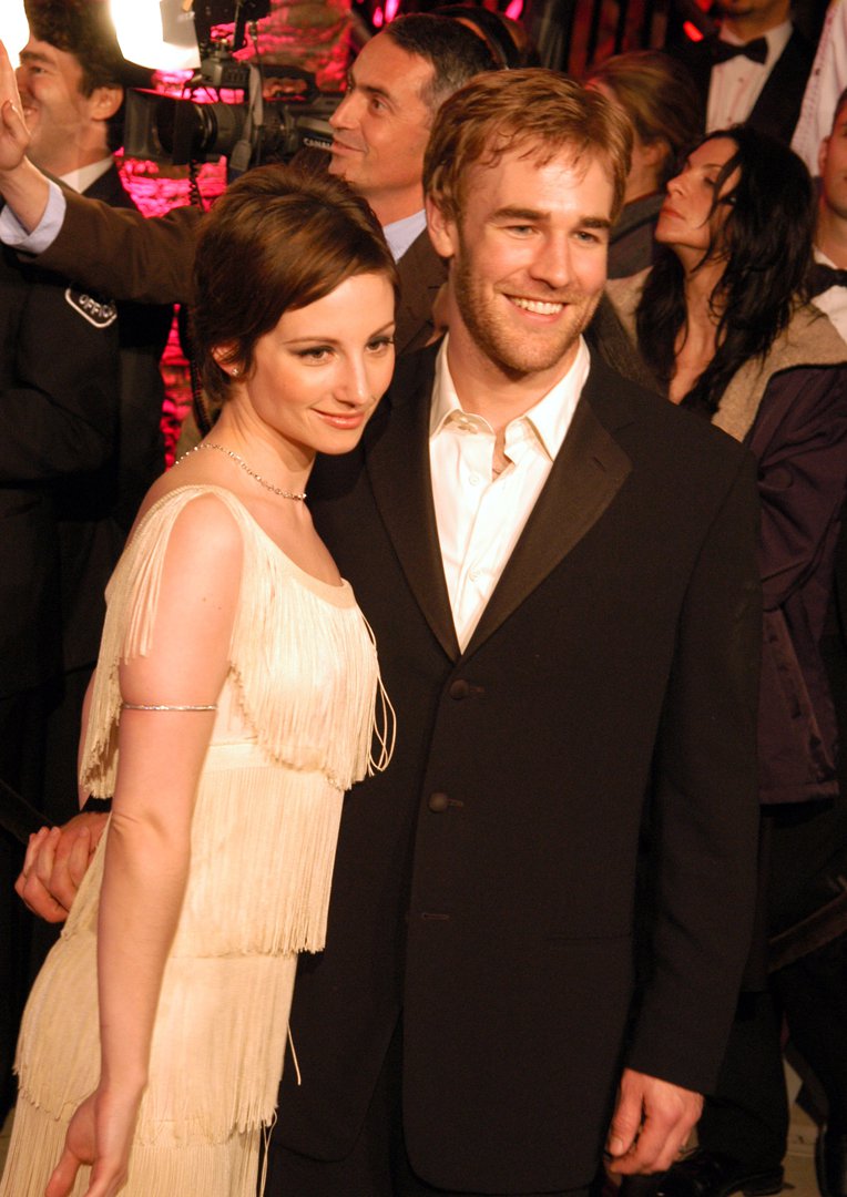 James Van Der Beek beams beside Heather McComb at the Vanity Fair Oscar Party. Her ivory fringe dress adds vintage glamour as she smiles serenely. Together, they exude effortless charm amid the Hollywood crowd.