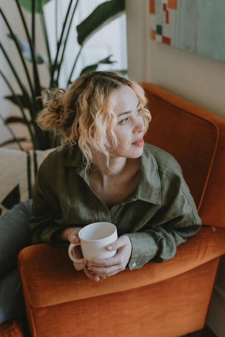 A woman sitting on a couch | Source: Unsplash