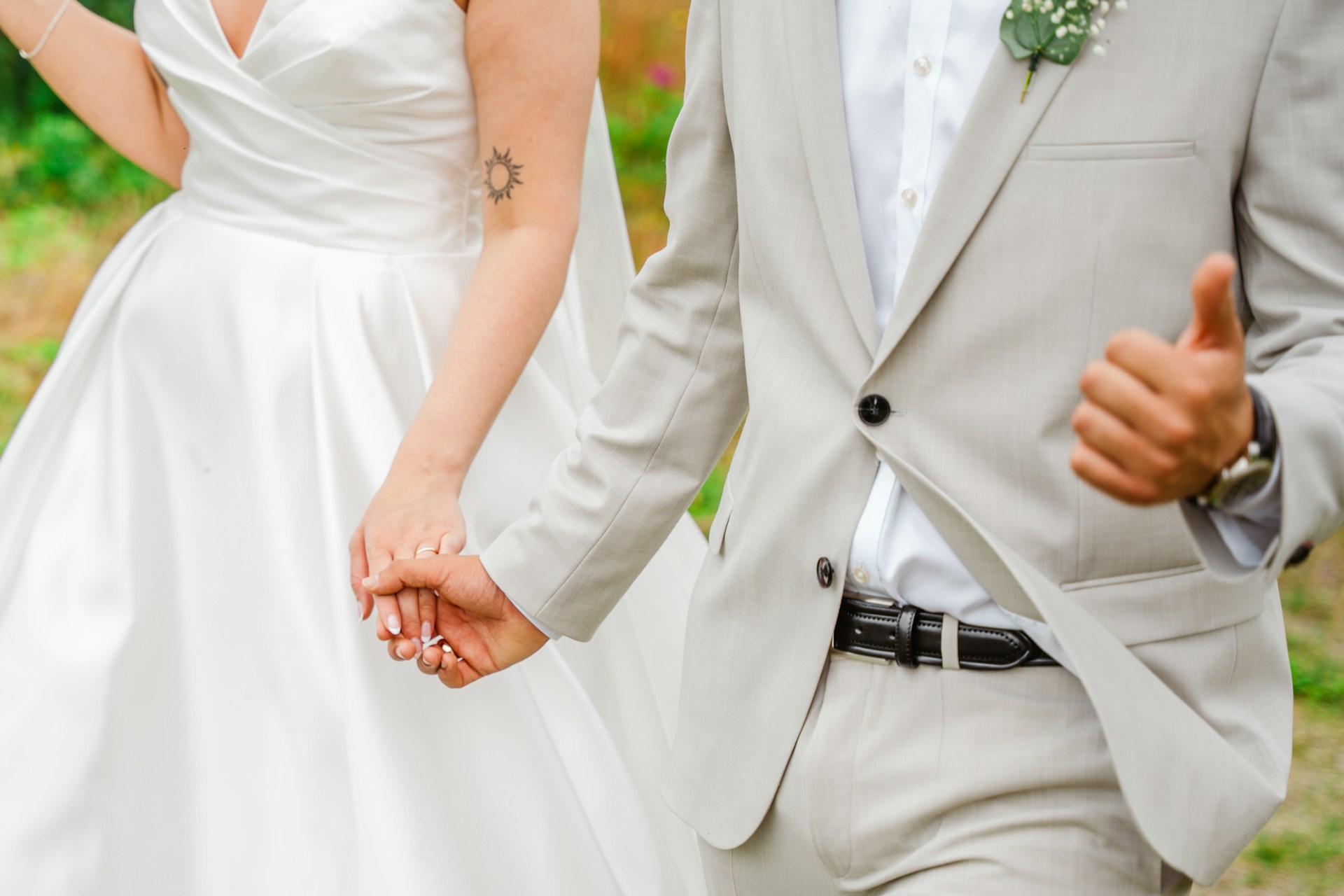 A bride and groom holding hands and walking together | Source: Unsplash