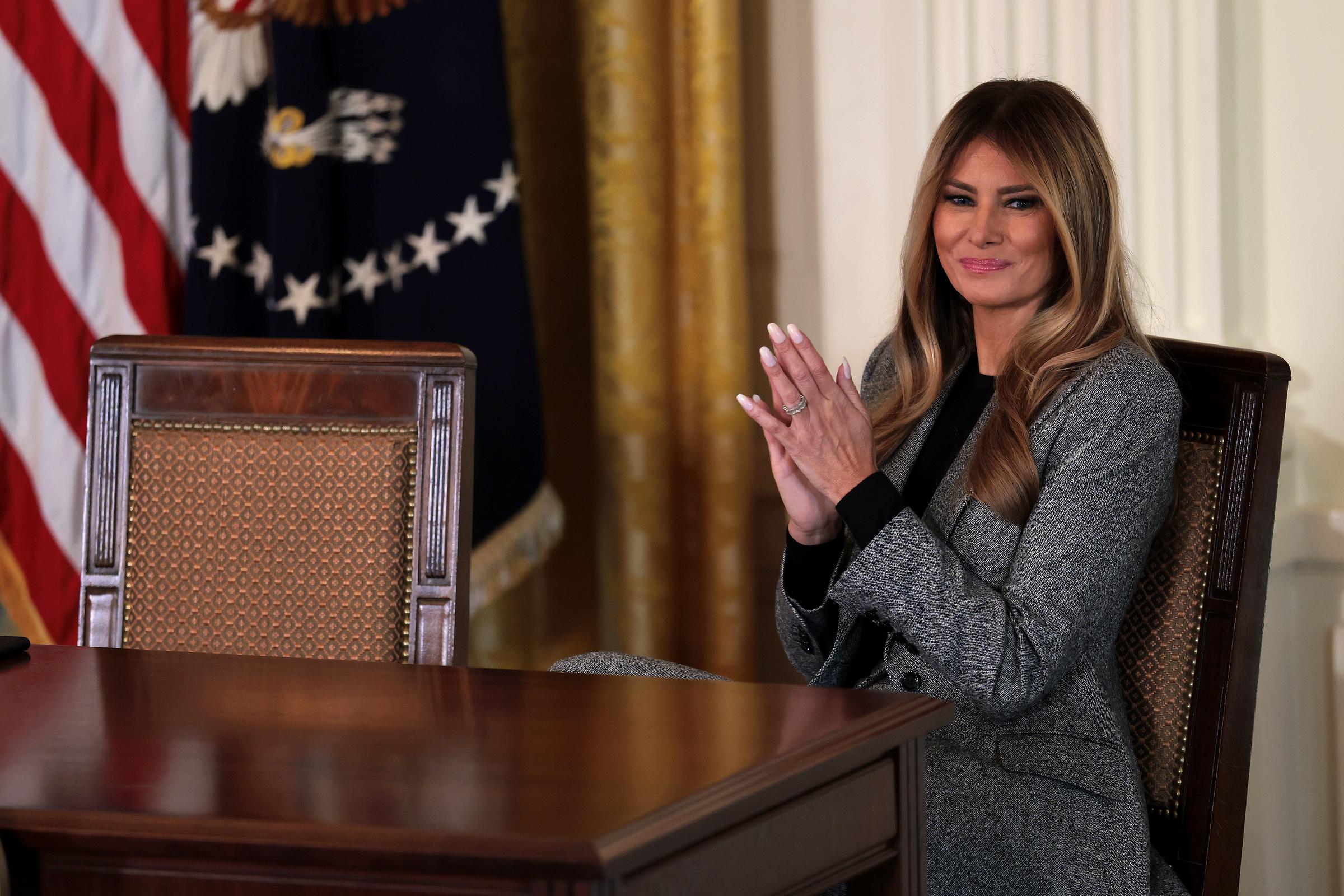 Melania Trump claps during the signing ceremony for the 