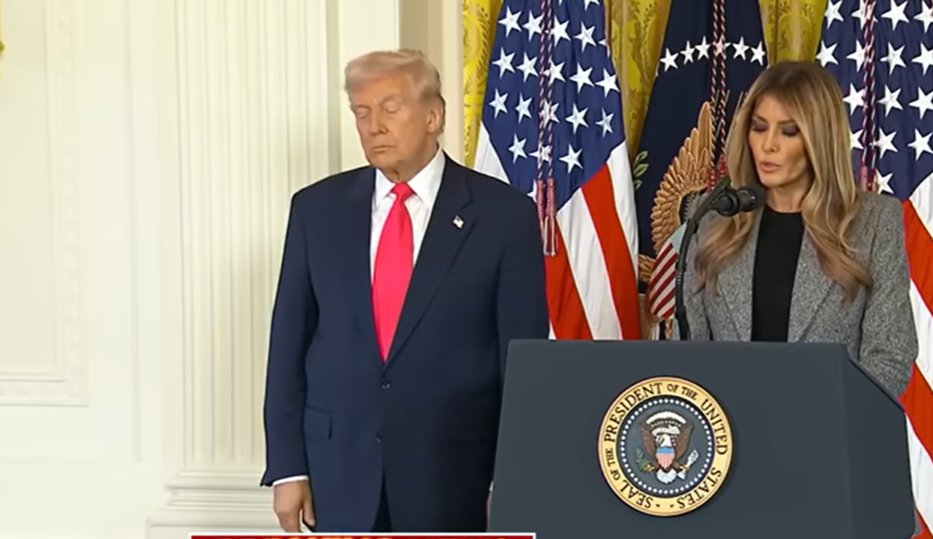 Donald Trump stands next to Melania as she delivers her speech during an executive order signing on November 13, 2025 | Source: YouTube/@FoxNews