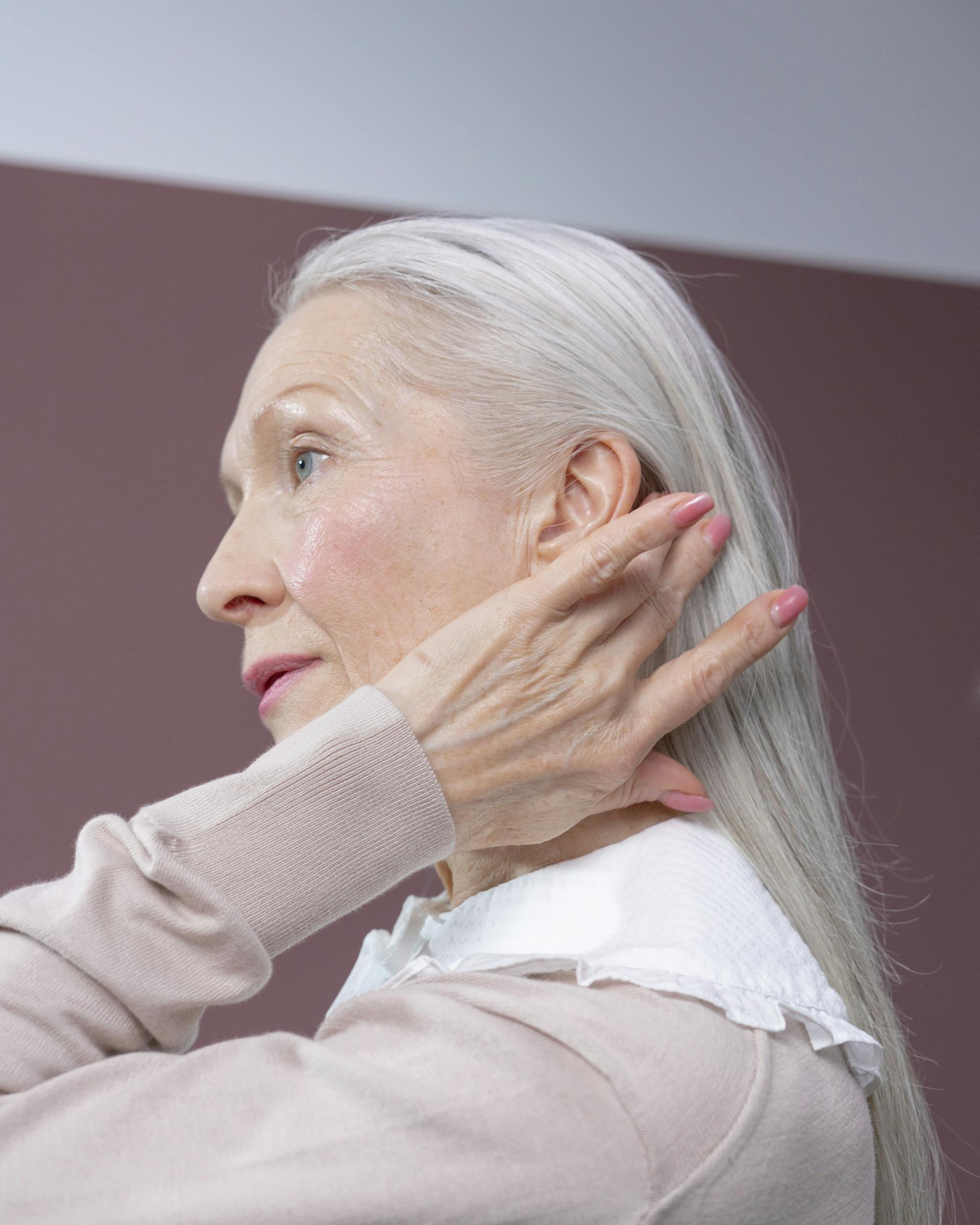 An older woman touching her hair | Source: Pexels
