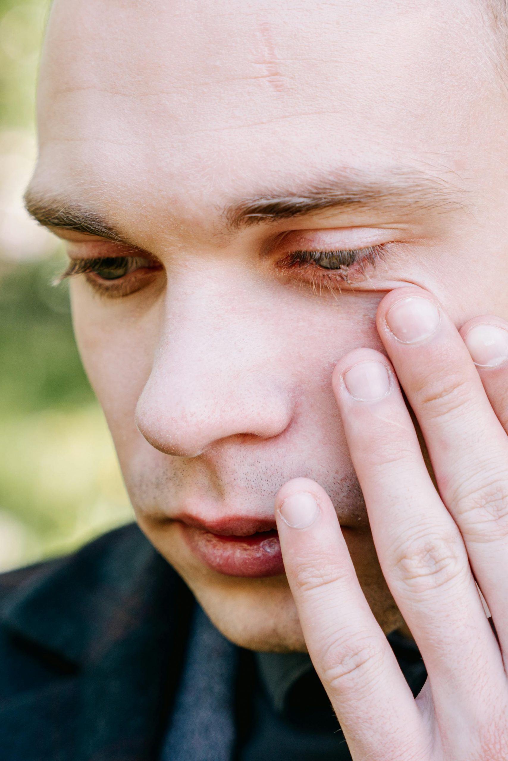 Close-up shot of a man wiping his tears | Source: Pexels