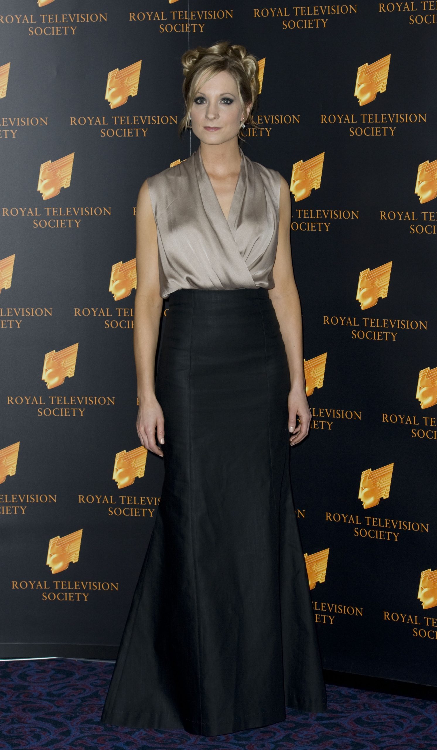 Joanne Froggatt arrived at the RTS Programme Awards in 2010 with an elegant updo and smoky eye makeup, wearing a taupe wrap top and high-waisted black skirt. Her red carpet look had a soft glamour that subtly echoed her role as the quietly resilient Anna Bates on