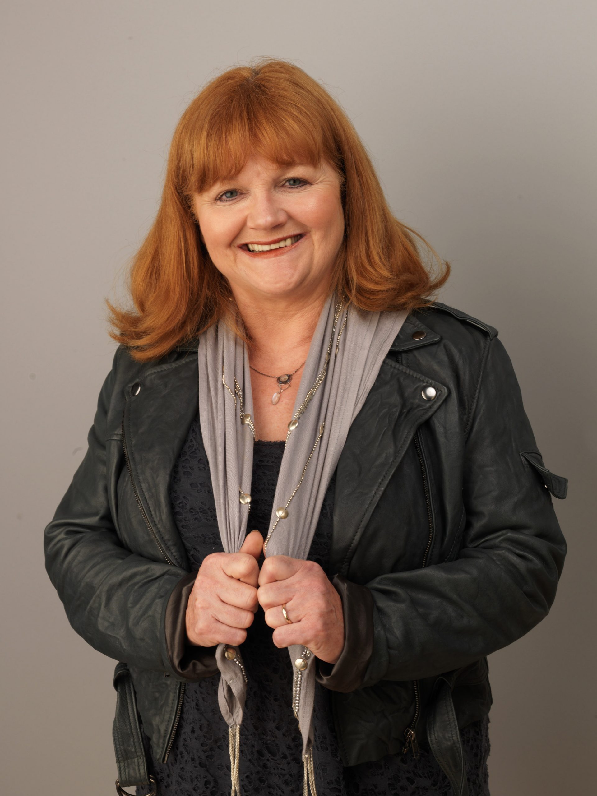 Lesley Nicol posed during the 2010 BFI London Film Festival with her signature red hair styled softly and a cheerful smile. Wearing a grey scarf and leather jacket, she gave off a relaxed and approachable vibe far removed from her stern but lovable